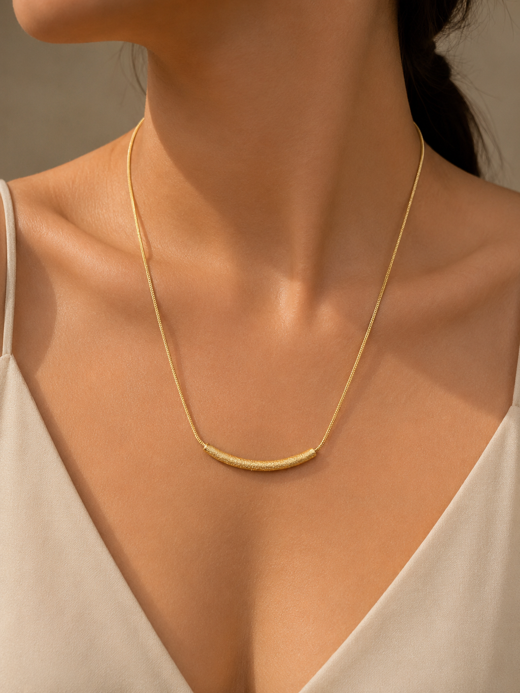 Gold Textured Curved Bar Necklace worn around neck
