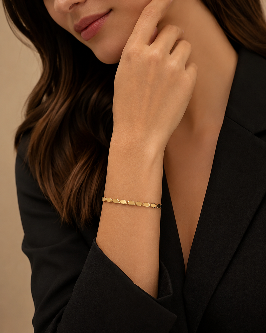 Gold Oval Disc Station Open Cuff Bracelet worn on wrist with black blazer