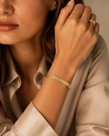 Gold Triple-Row Wheat Grain Textured Open Cuff Bracelet worn on model with silk shirt