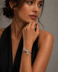 Silver Textured Ribbon Bow Cuff Bracelet worn on wrist with black halter