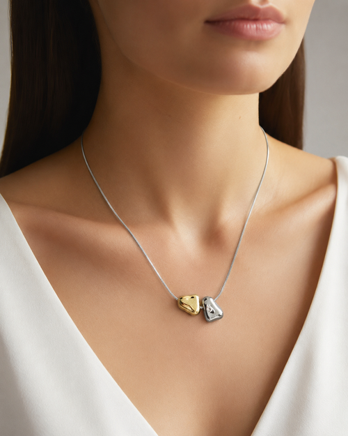 Bi-Tone Double Pebble Heart Necklace worn around neck