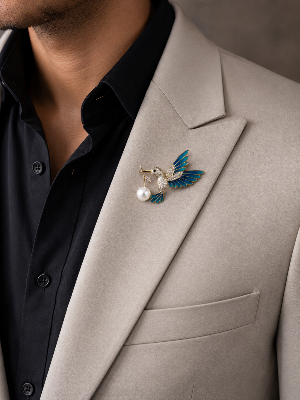 Gold Teal Enamel Hummingbird Pavé Body Lapel Brooch Pin with Pearl Drop worn on model on cream blazer lapel with black shirt