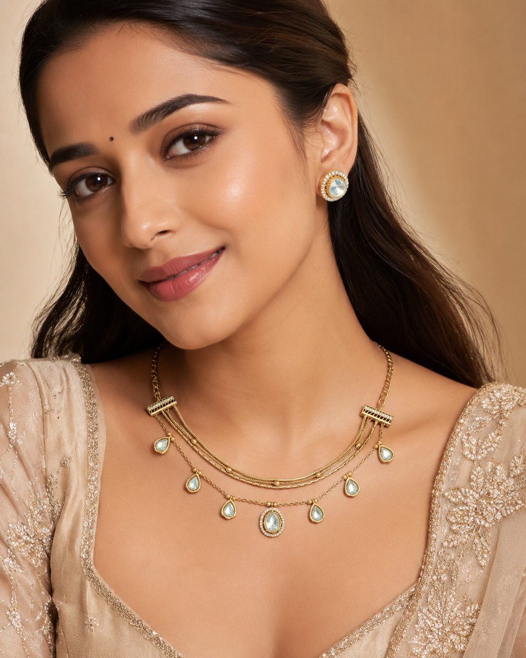 Gold Triple-Strand Polki Pear-Drop Charm Necklace & Oval Polki Pavé Stud Earrings Set worn on model with champagne embroidered lehenga