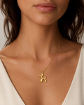 Gold Balloon Dog Pendant Necklace worn around neck