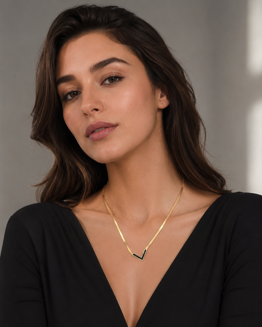 Gold Black Enamel V-Chevron Herringbone Chain Necklace worn on model with black deep V-neck top