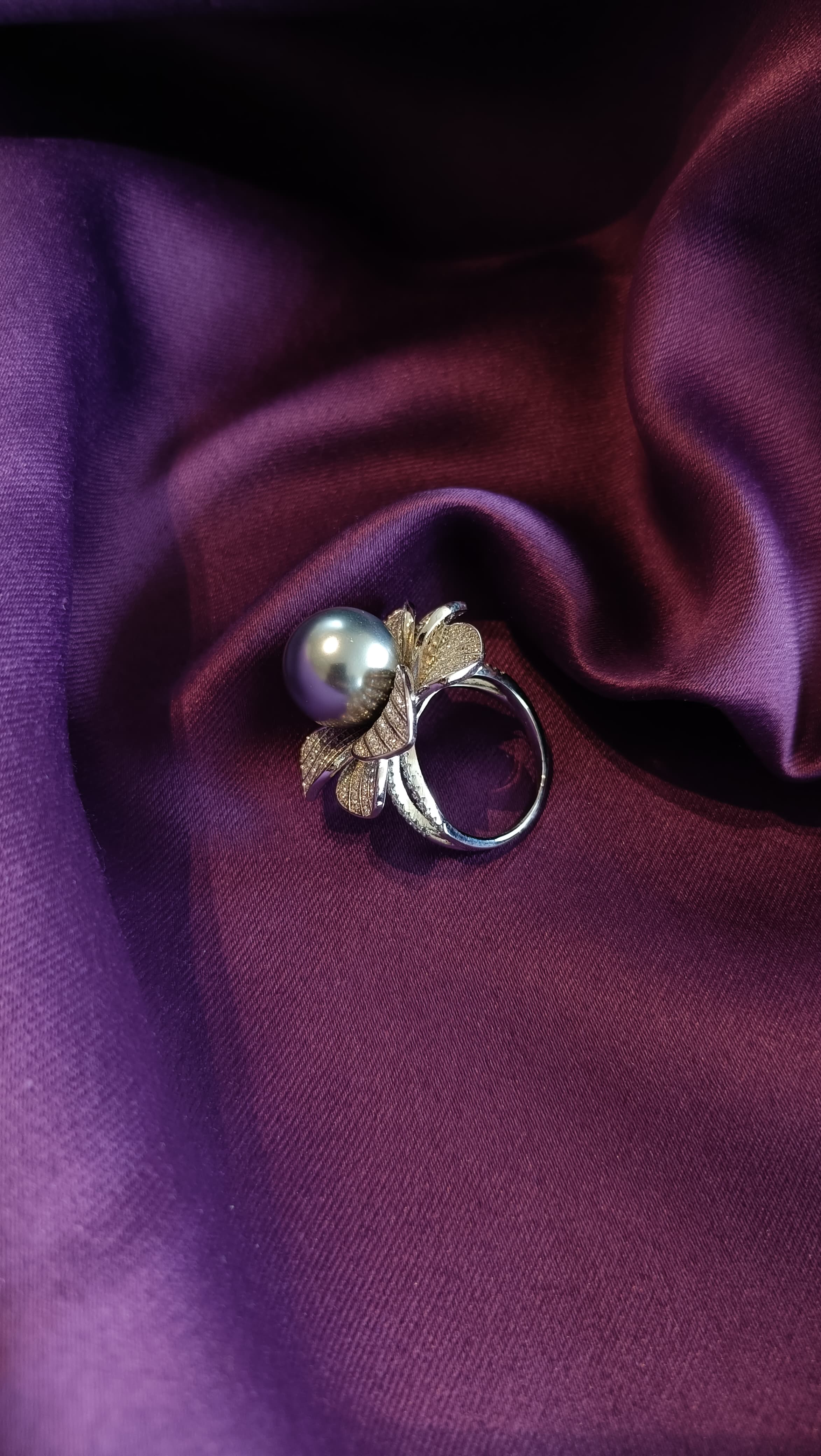 Silver Pavé Floral Ring with Tahitian Pearl Centre side view on purple fabric