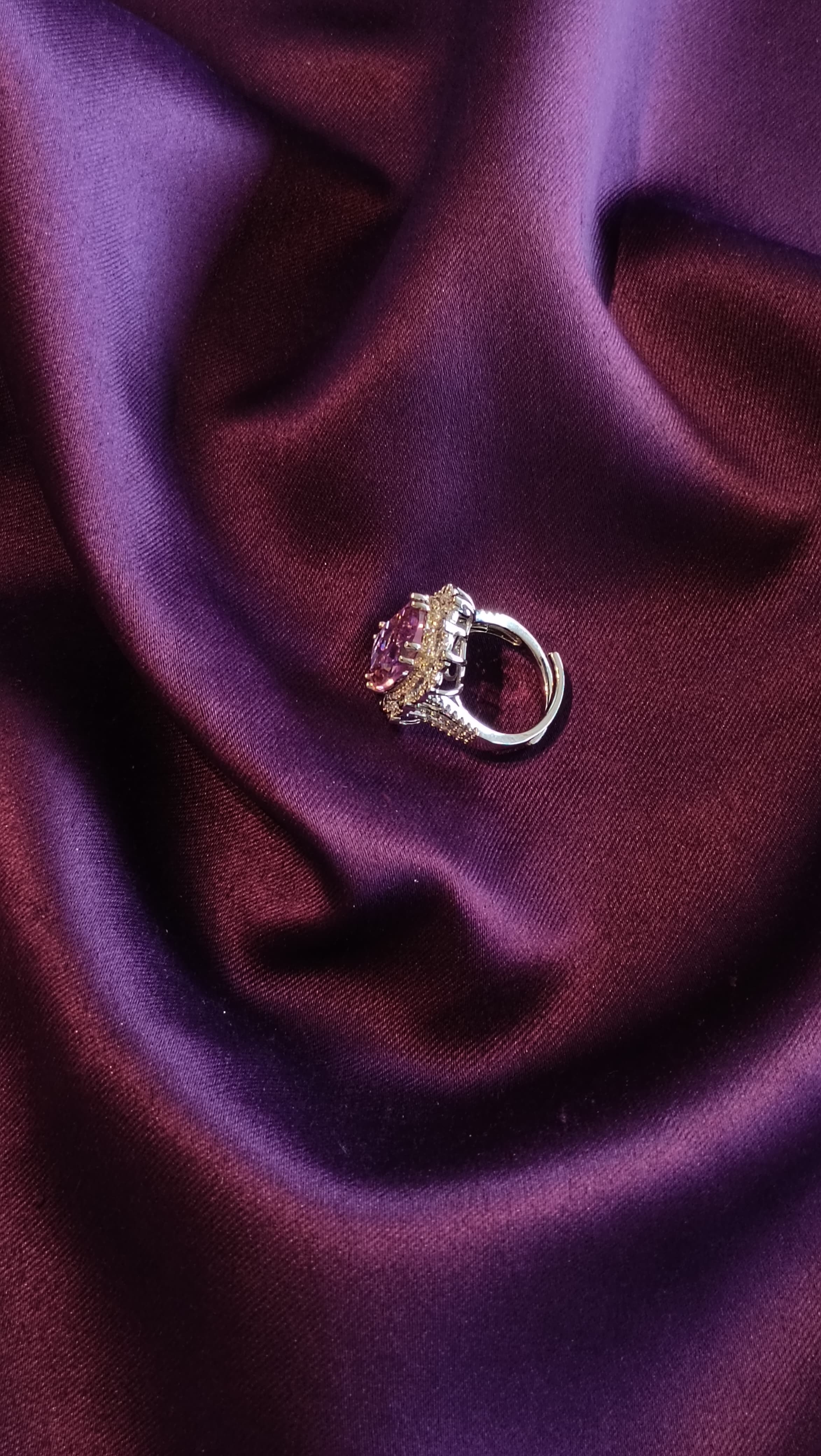 Silver Halo Ring with Blush Pink Oval Stone side view on purple fabric