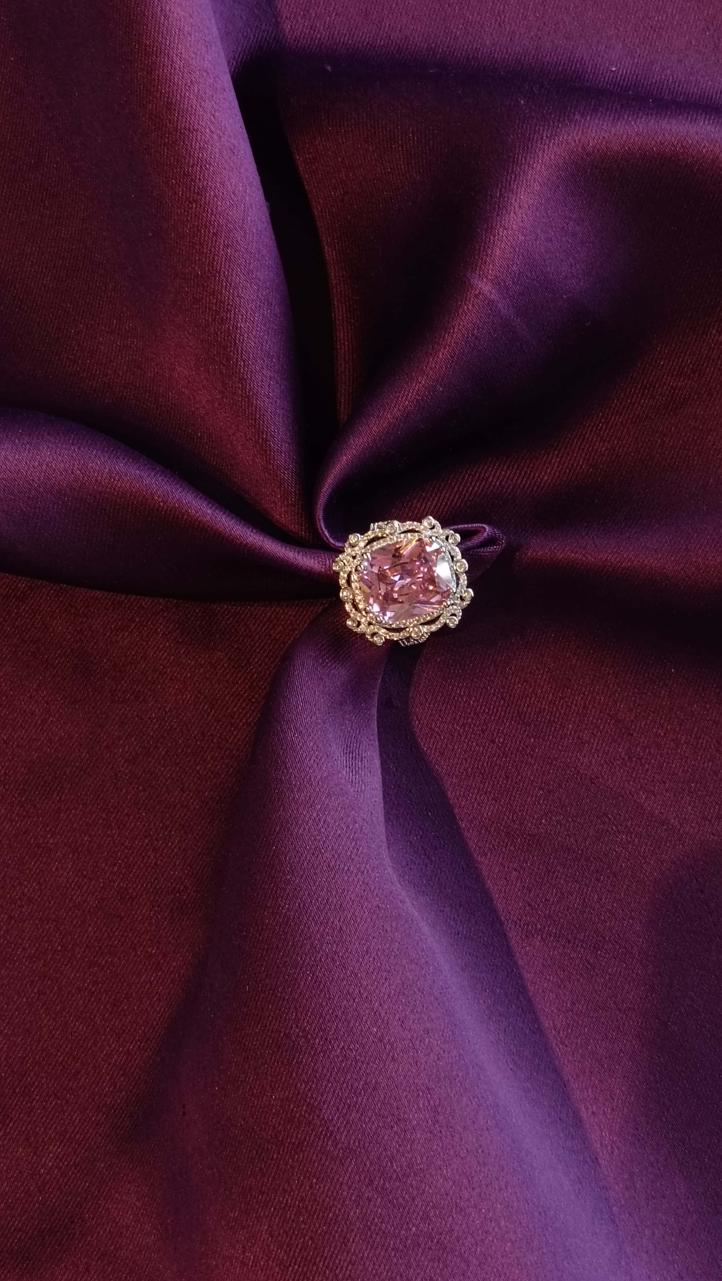 Silver Halo Ring with Blush Pink Oval Stone top view on purple fabric