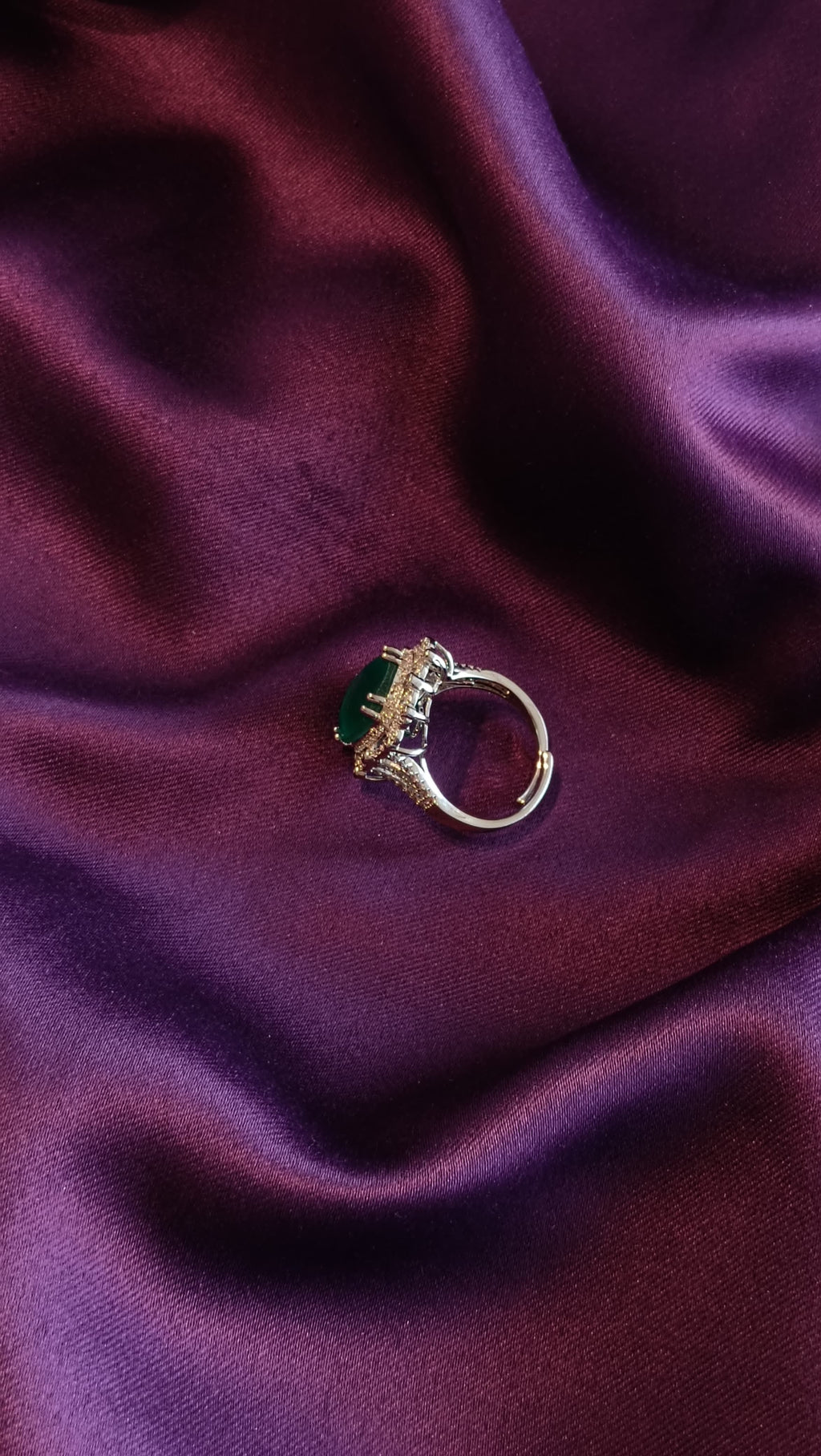 Gold Emerald Green Cushion Halo Cocktail Ring side view on purple fabric