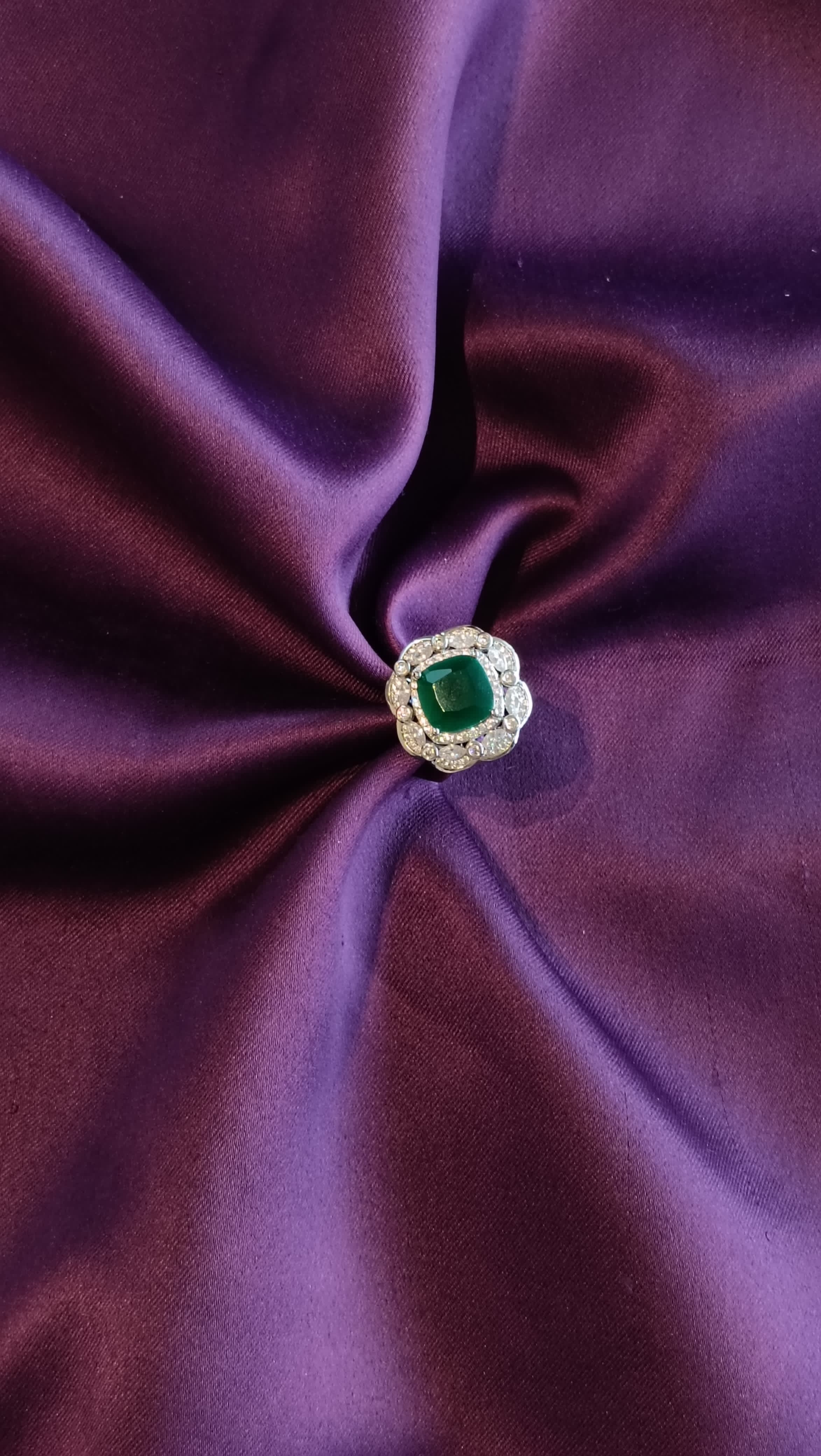 Silver Double Halo Emerald Green Cushion Ring top view on purple fabric
