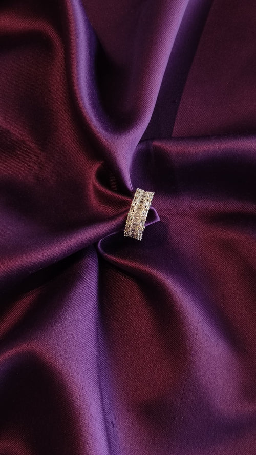 Gold Baguette & Pavé Wide Eternity Band top view on purple fabric