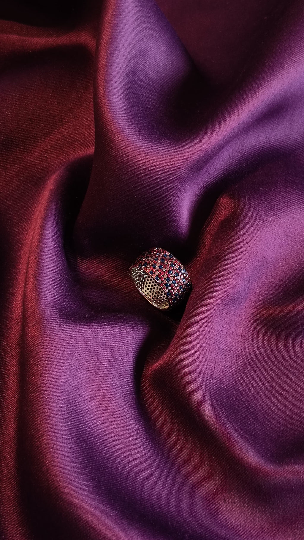 Multi-Colour Pavé Wide Dome Band Ring side view on purple fabric