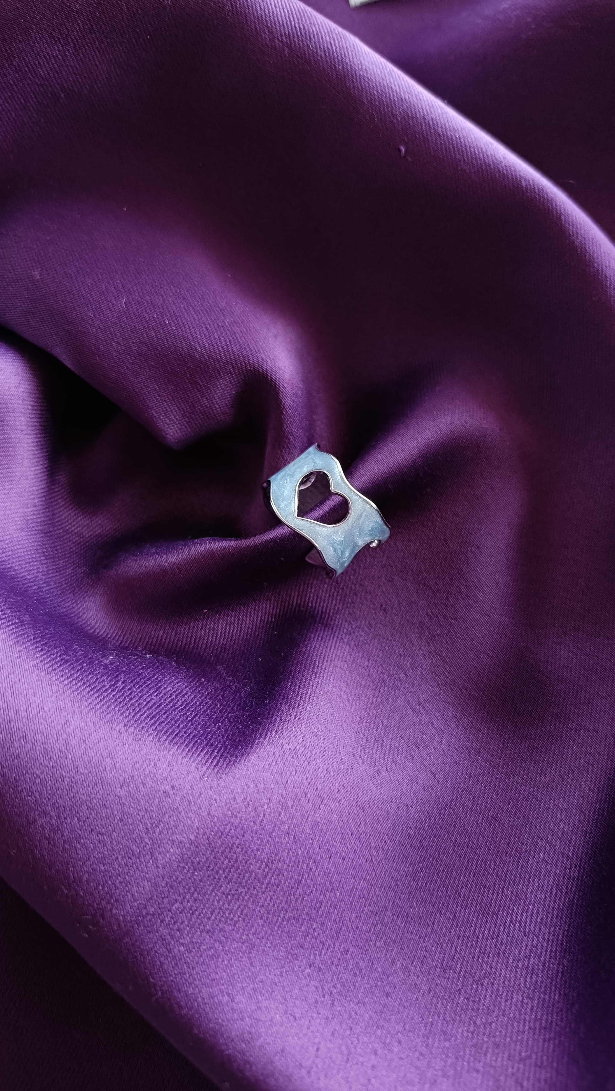 Open Heart Silver Ring on purple fabric