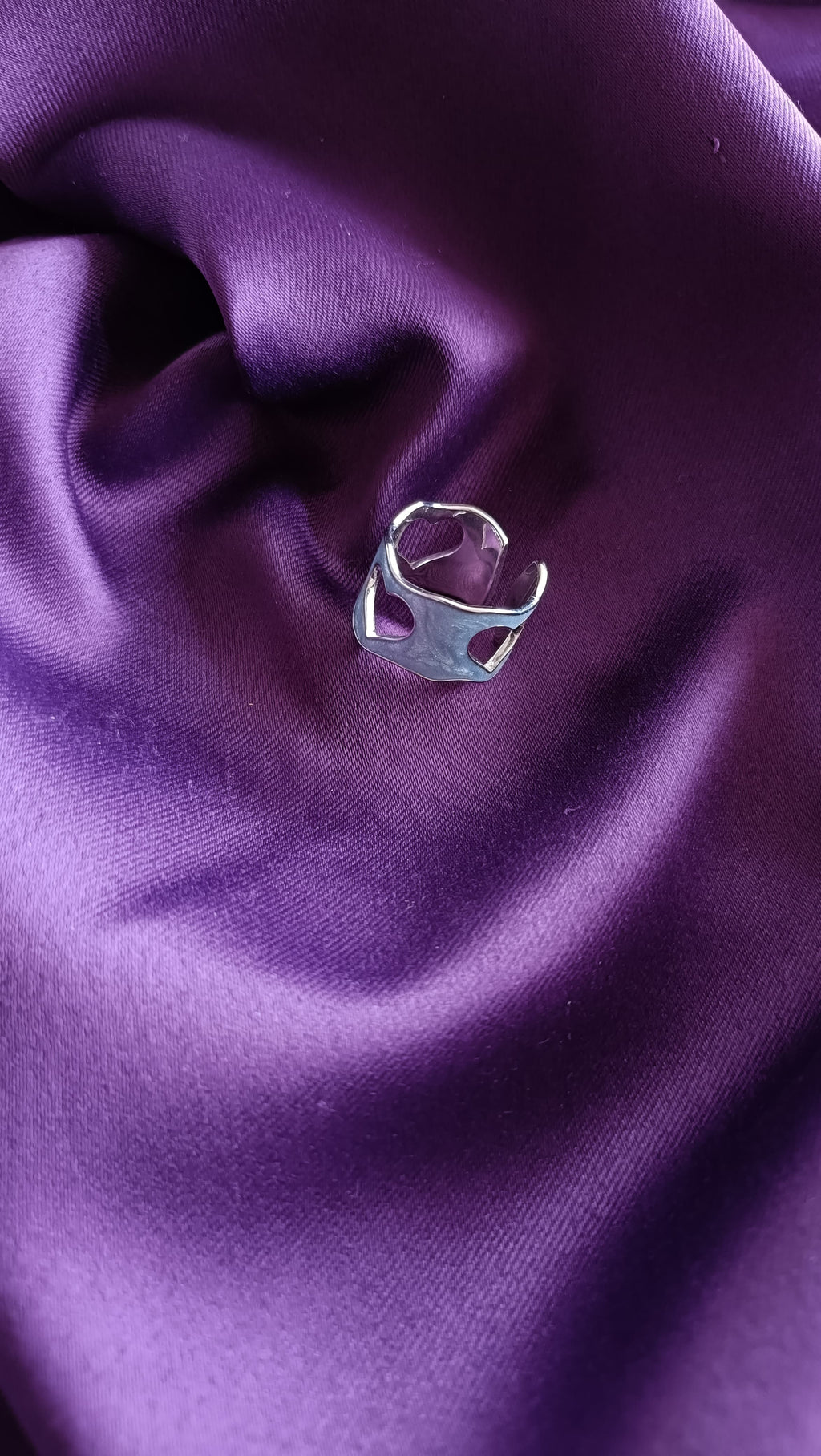 Open Heart Silver Ring side view on purple fabric