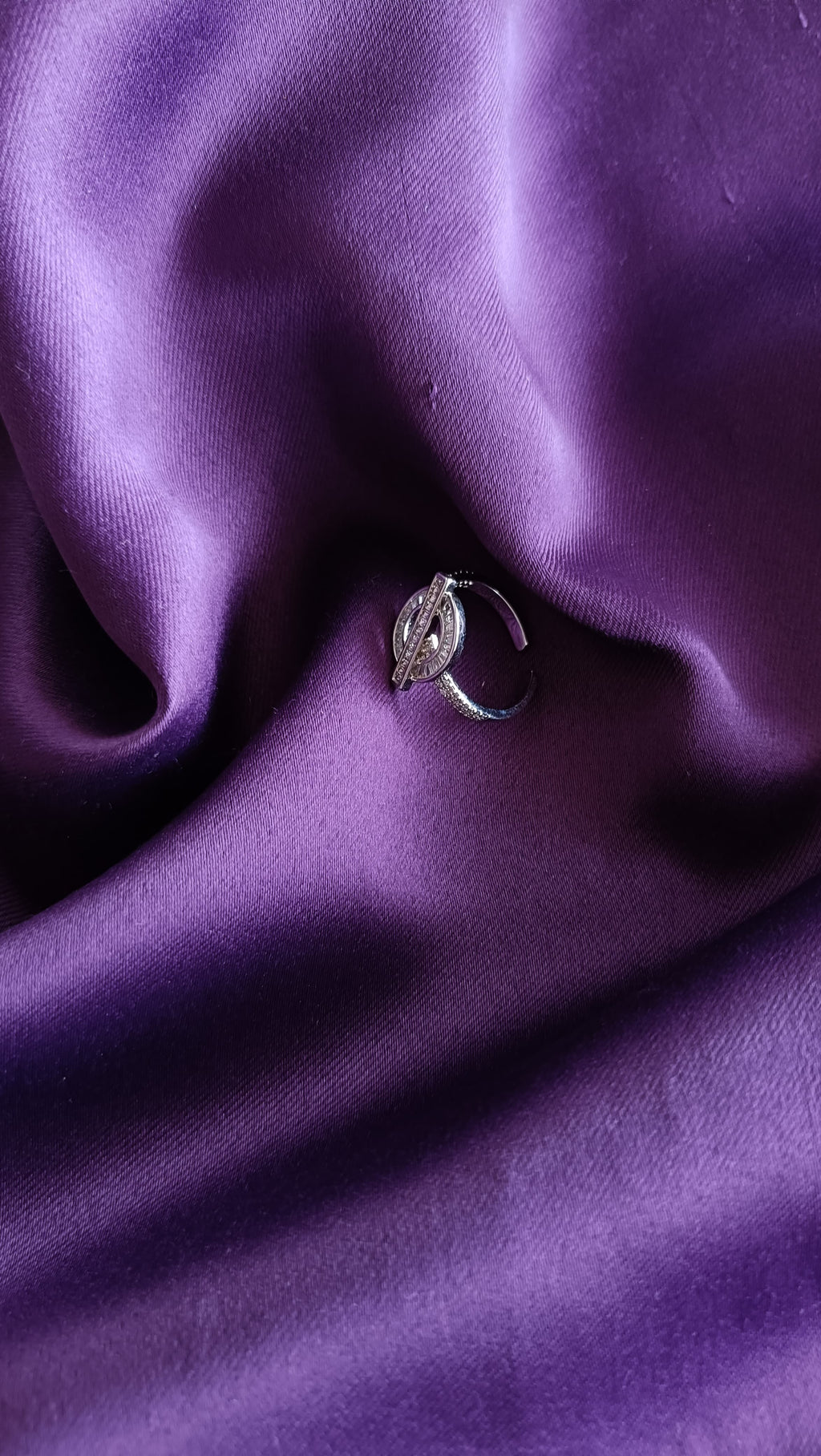 Crystal OT Clasp Silver Ring flat lay on purple fabric