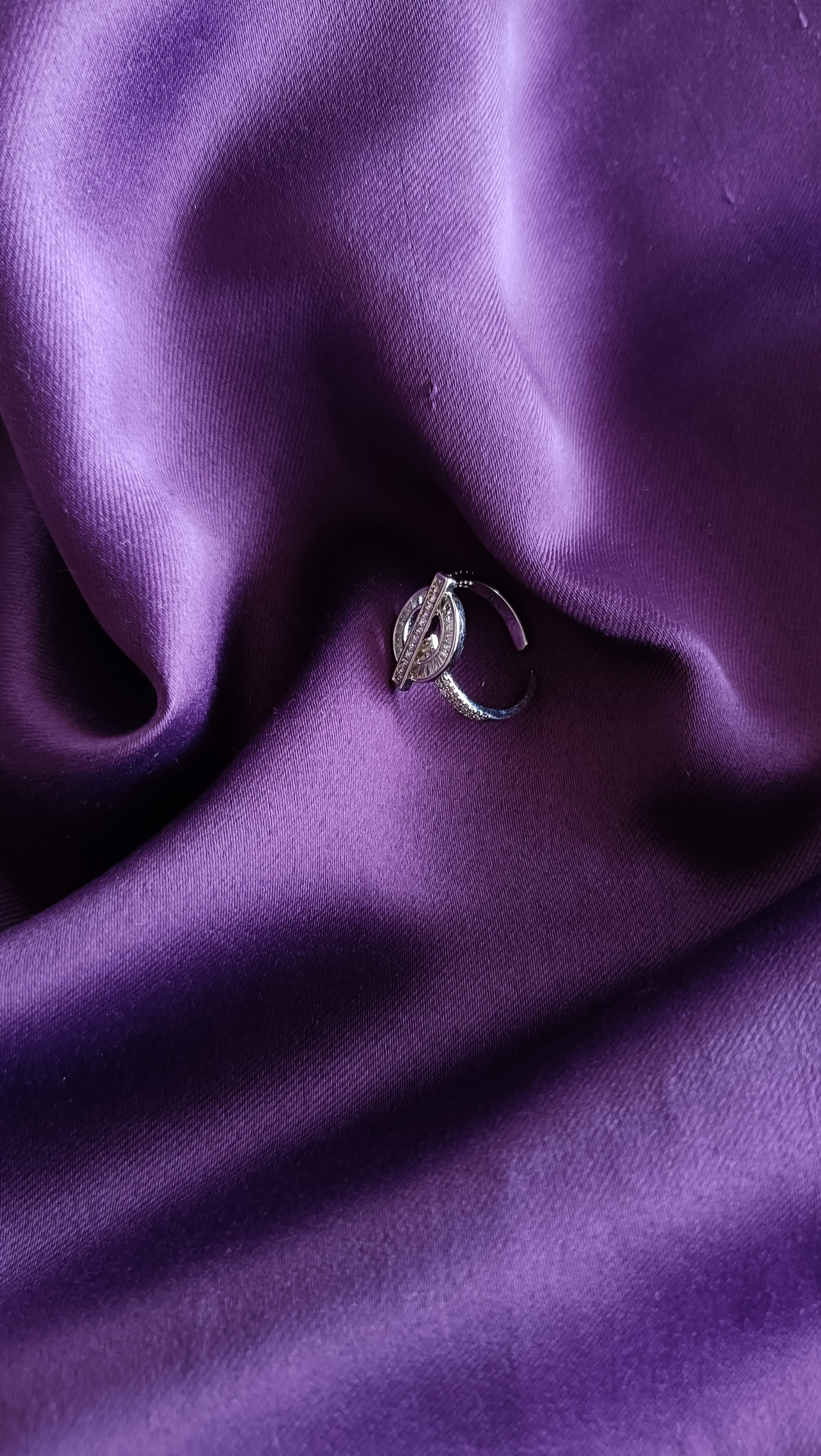 Crystal OT Clasp Silver Ring flat lay on purple fabric