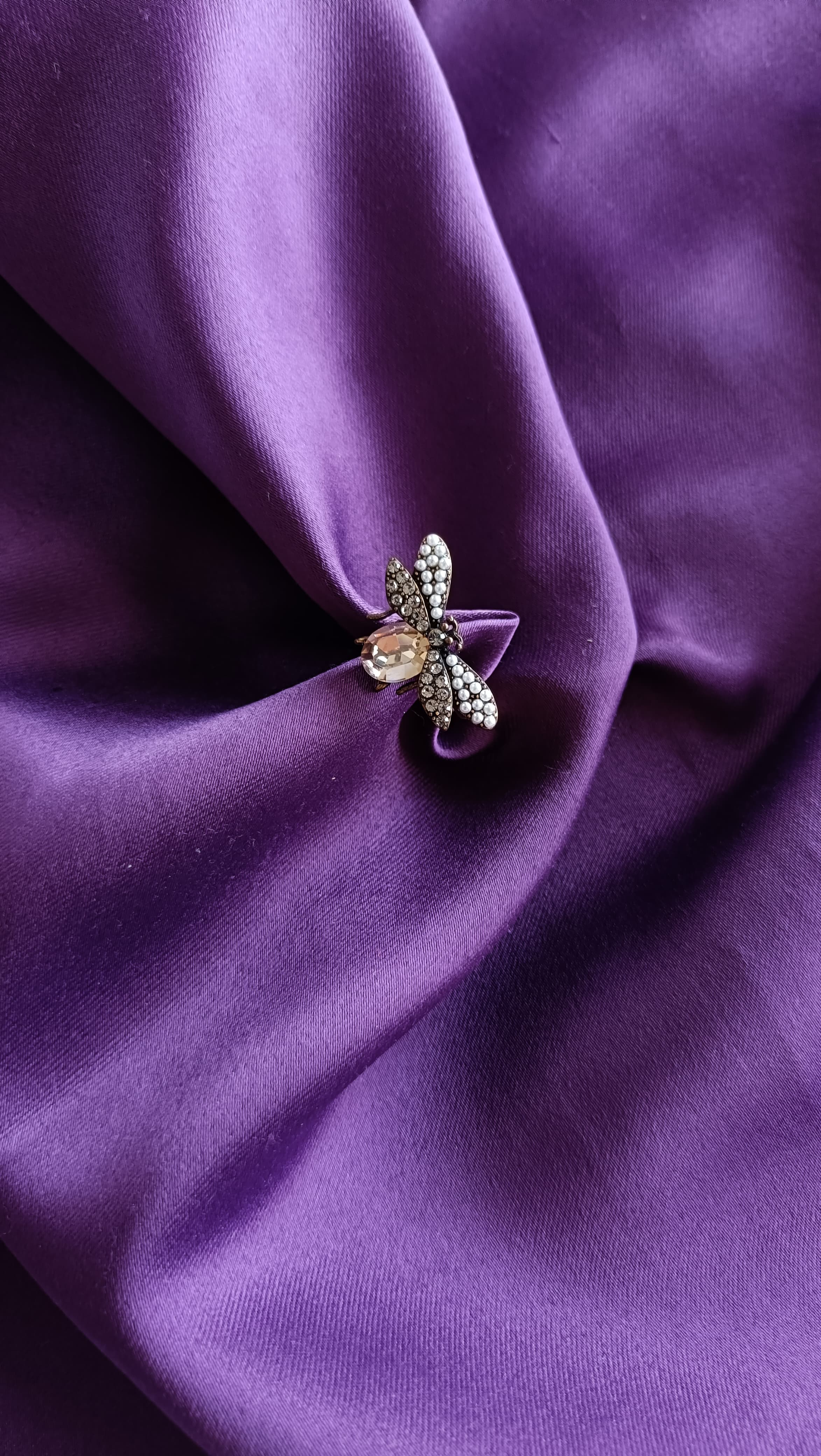 Gunmetal Bee Ring close-up on purple fabric
