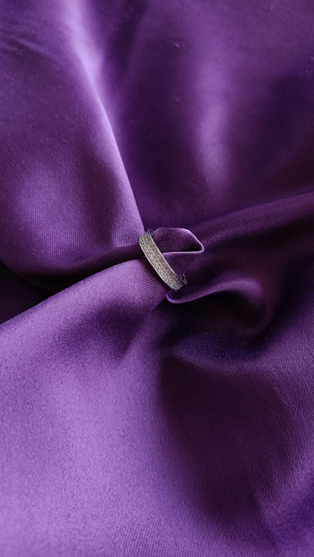 Double Row Pavé Crystal Band Ring on purple fabric close-up