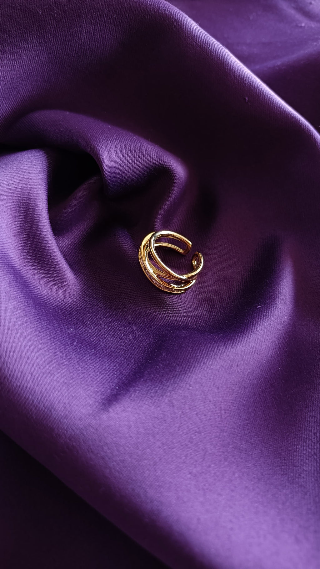 Gold Triple Band Pavé Ring flat lay on purple fabric