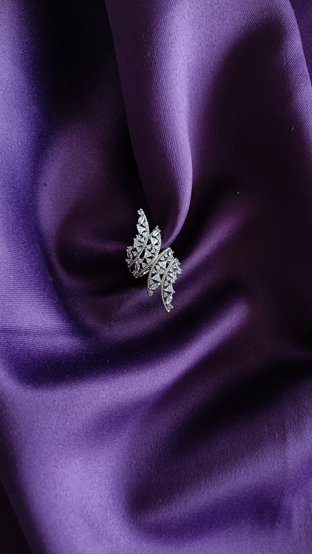 Crystal Maple Leaf Statement Ring flat lay on purple fabric