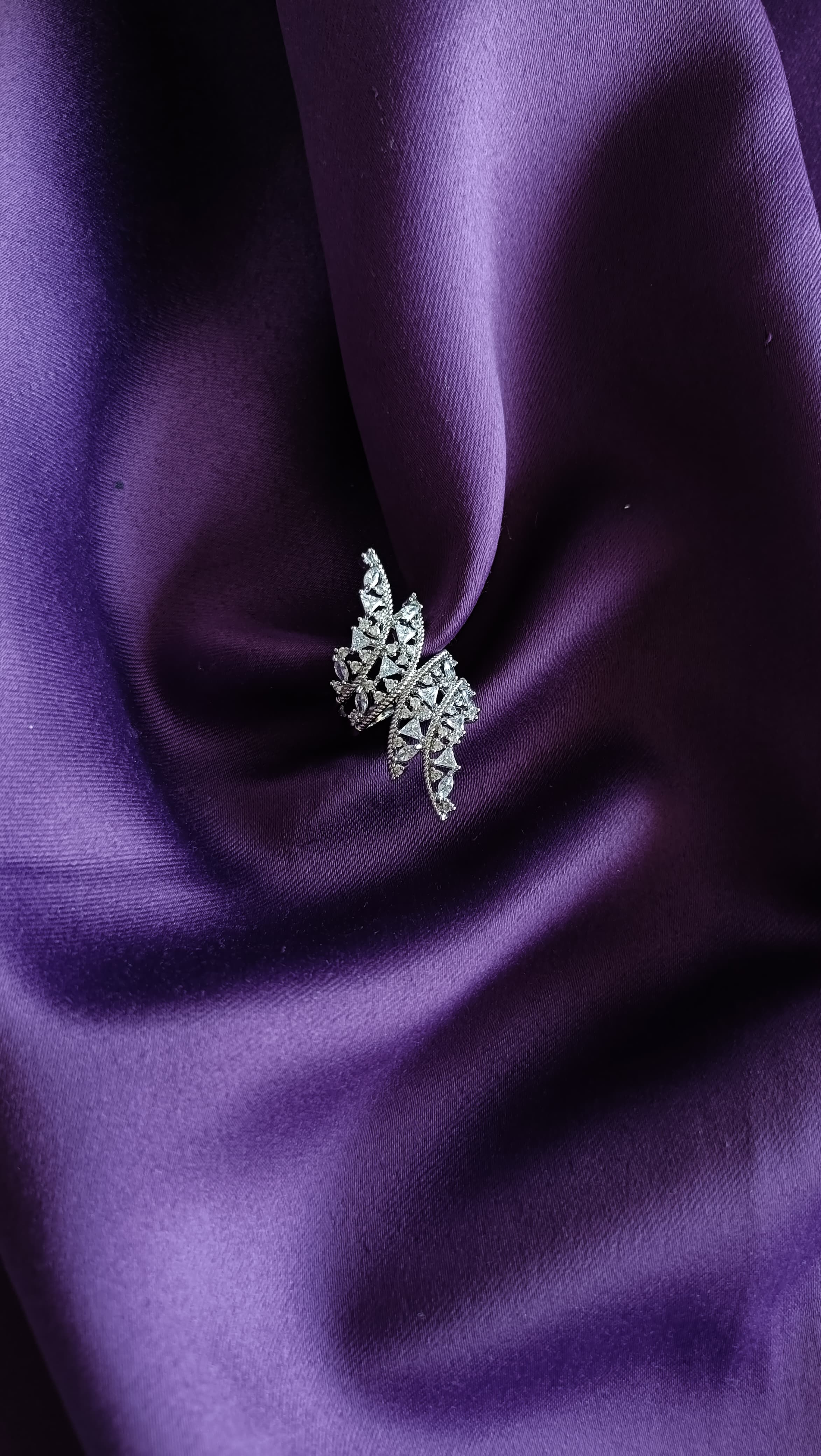 Crystal Maple Leaf Statement Ring flat lay on purple fabric