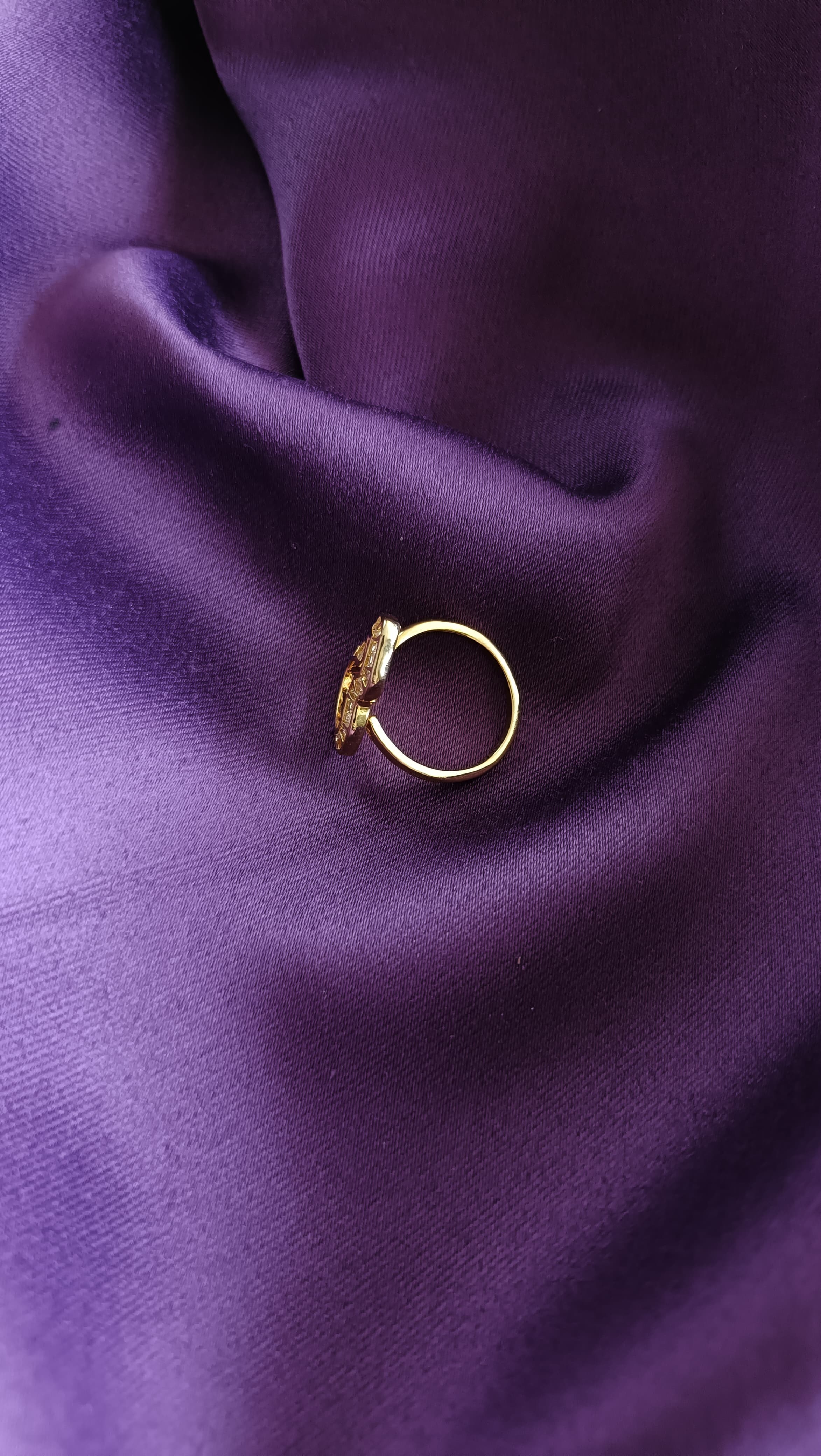 Gold Open Wave Baguette Ring side view on purple fabric