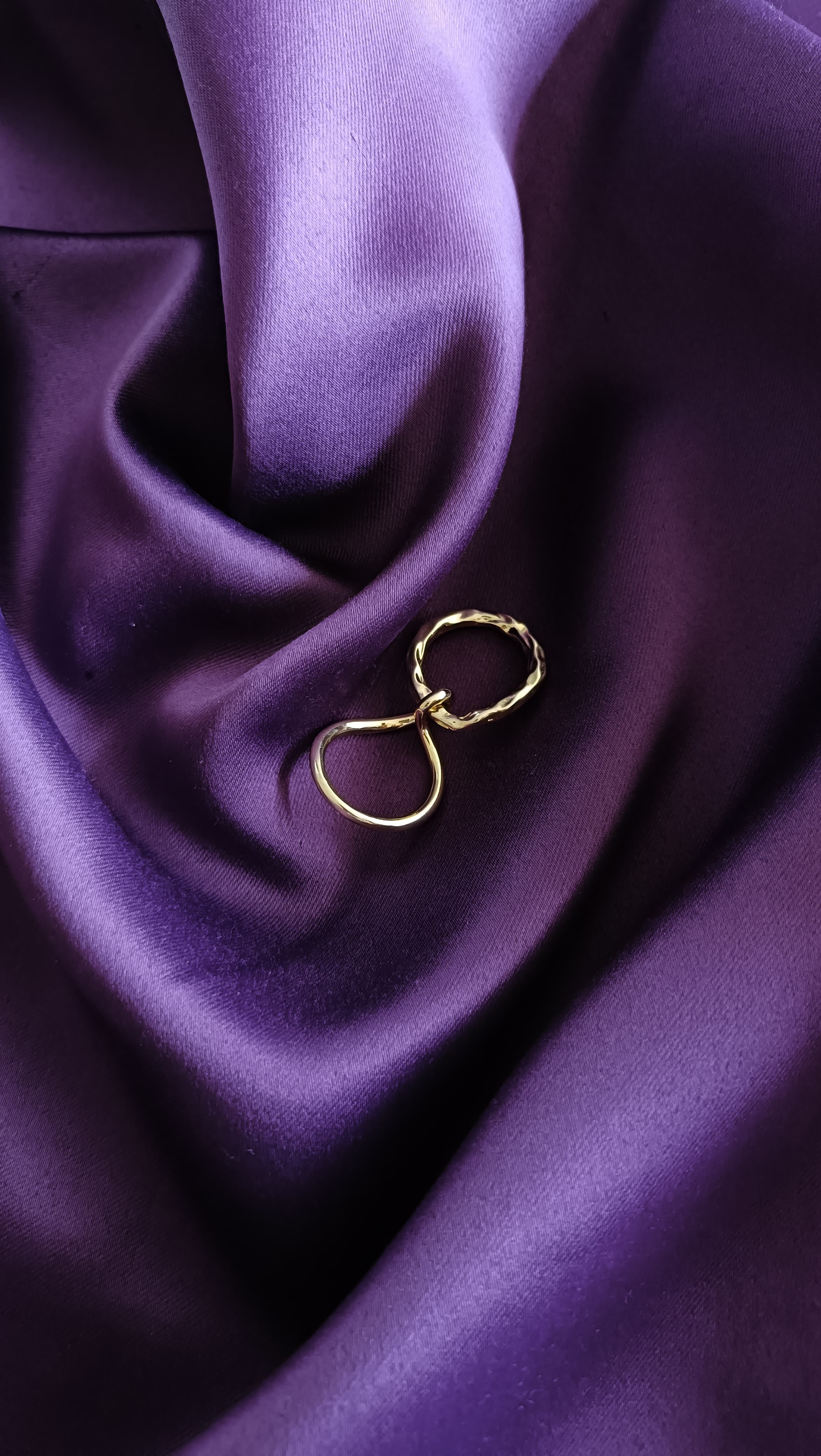 Gold Twisted Wire Stacking Ring Set flat lay on purple fabric