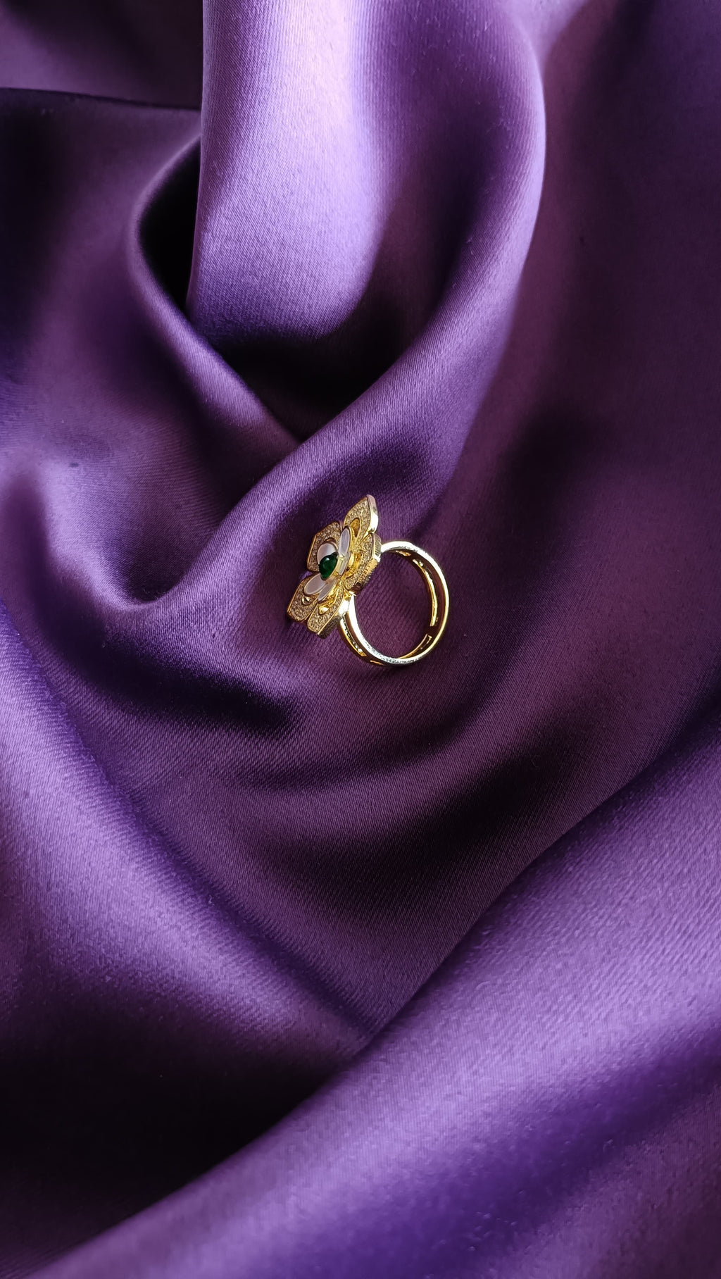 Gold Floral Ring side view on purple fabric