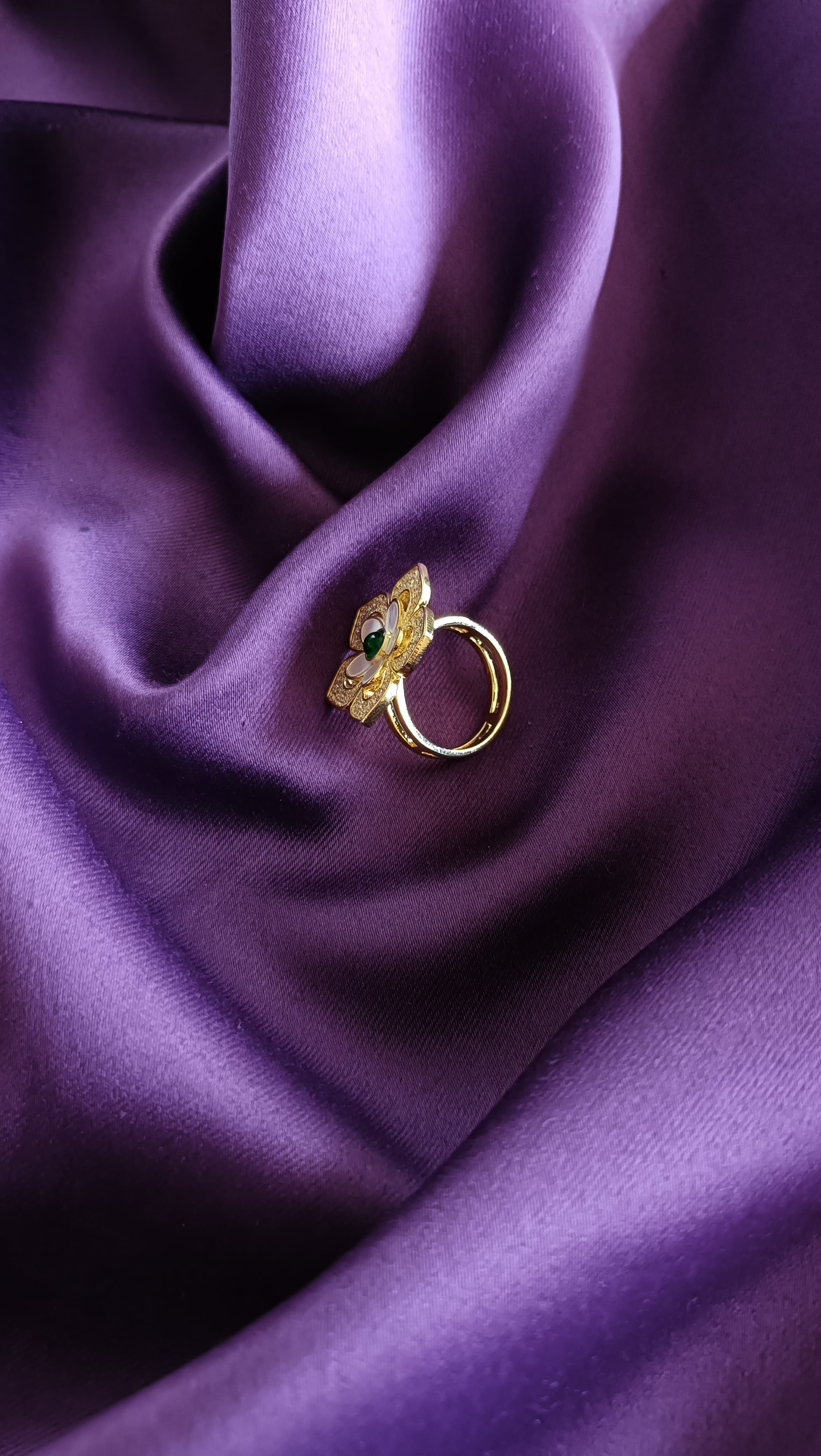 Gold Floral Ring side view on purple fabric
