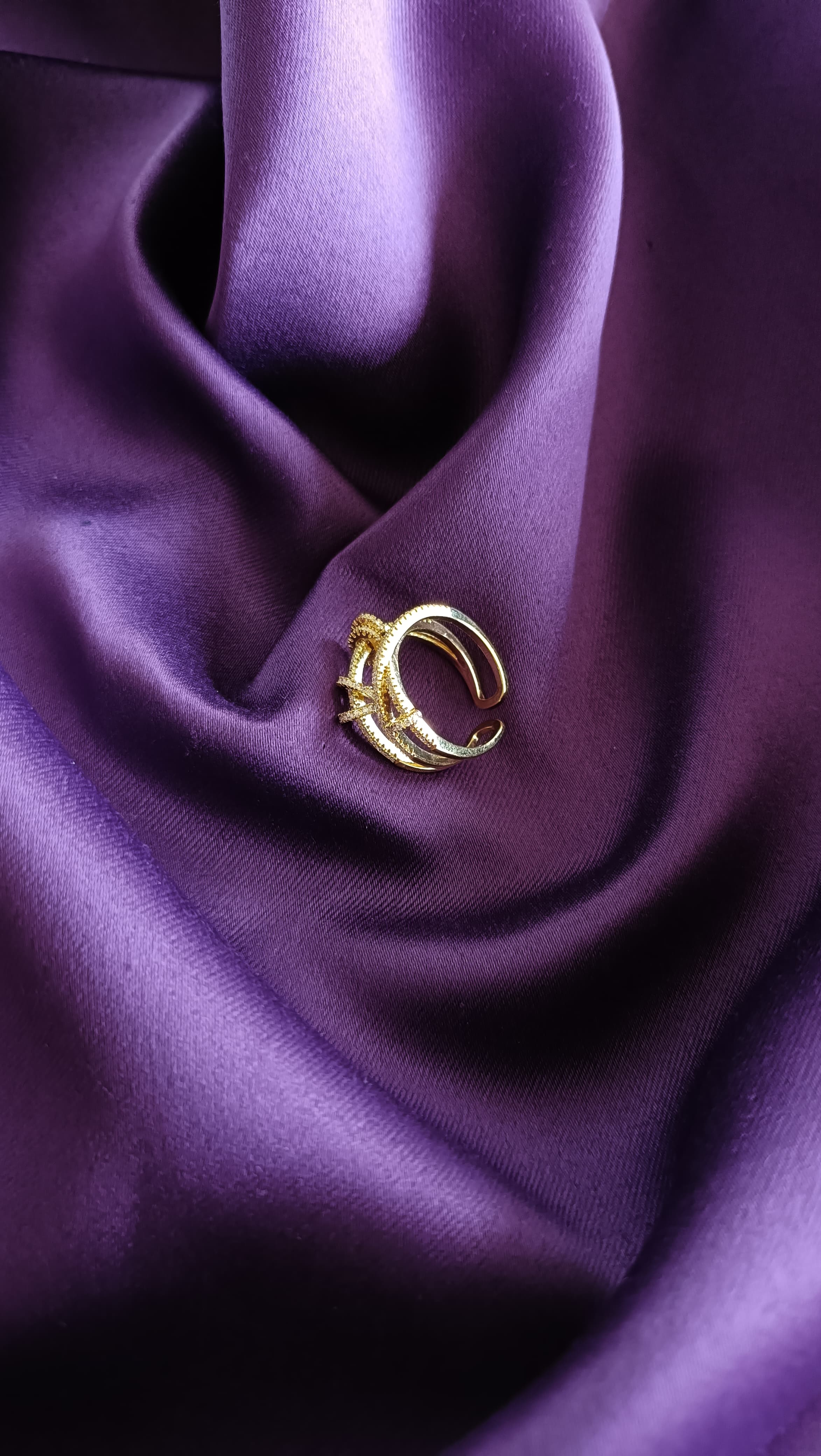 Gold Crystal Knot Double Band Ring side view on purple fabric