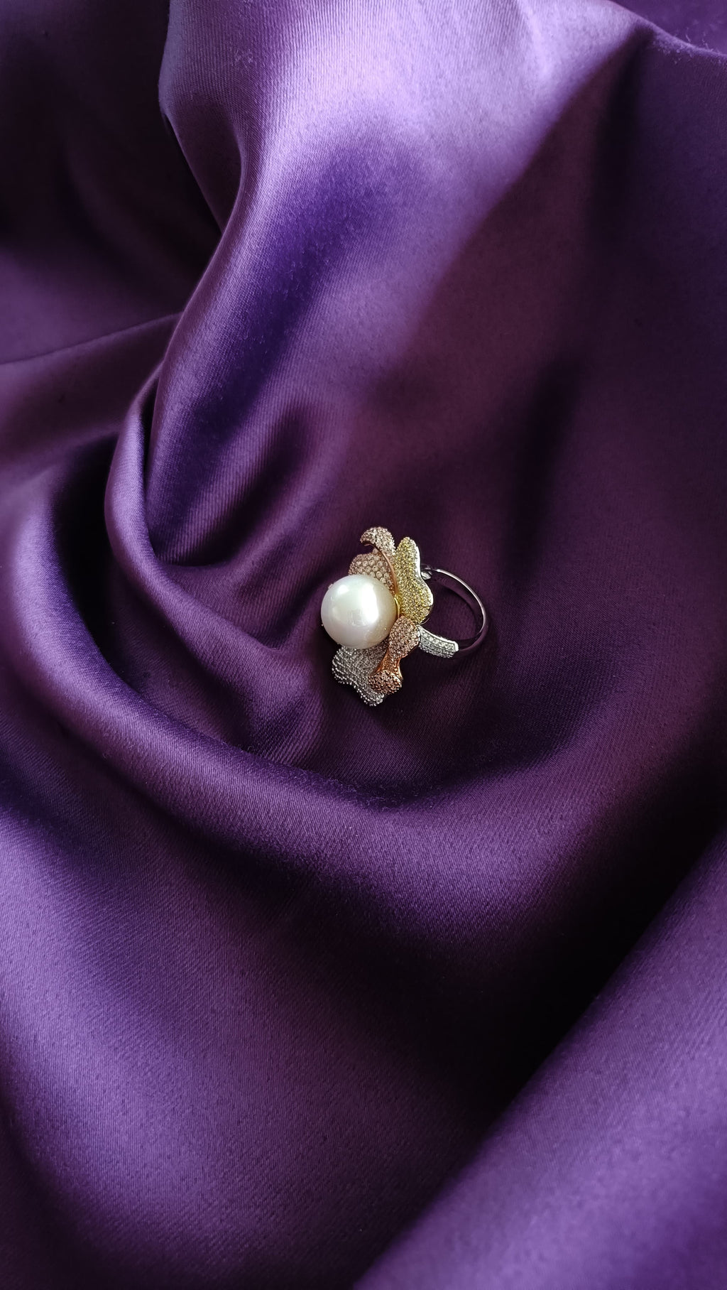 Tri-Tone Pavé Floral Ring with Freshwater Pearl side view on purple fabric