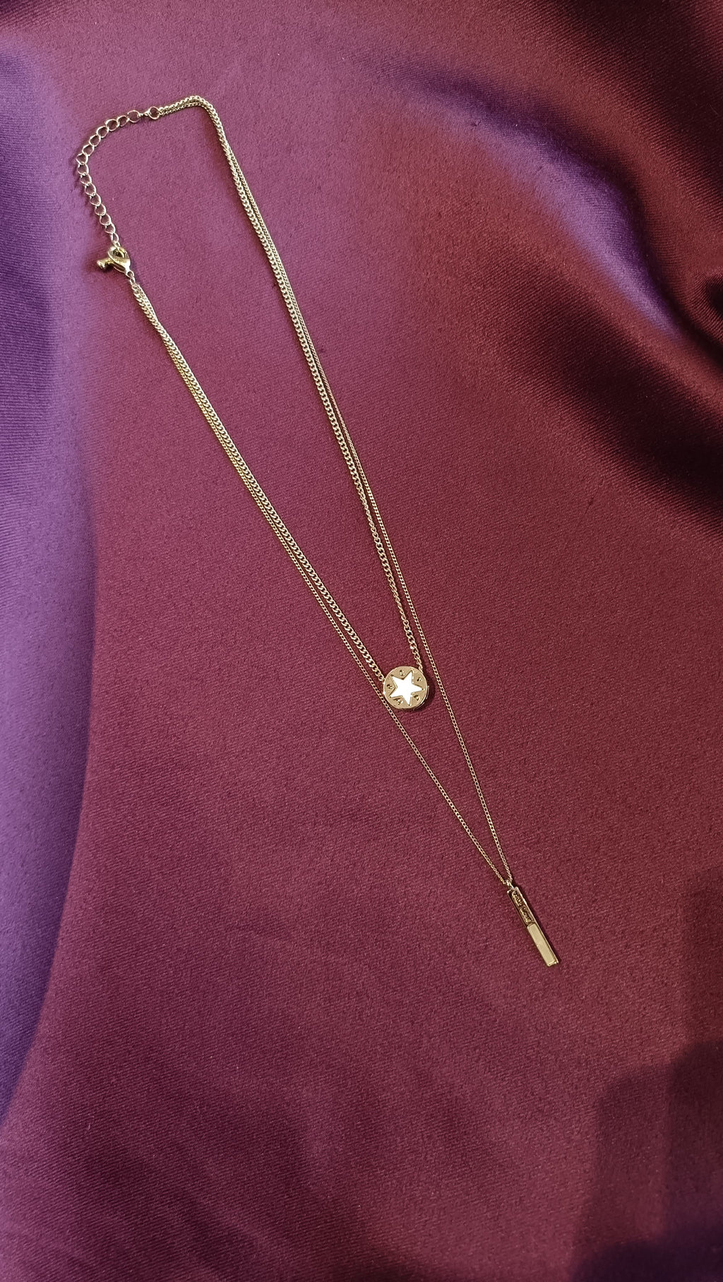 Silver Double-Layer Star Coin & Bar Lariat Necklace Set flat lay on purple fabric