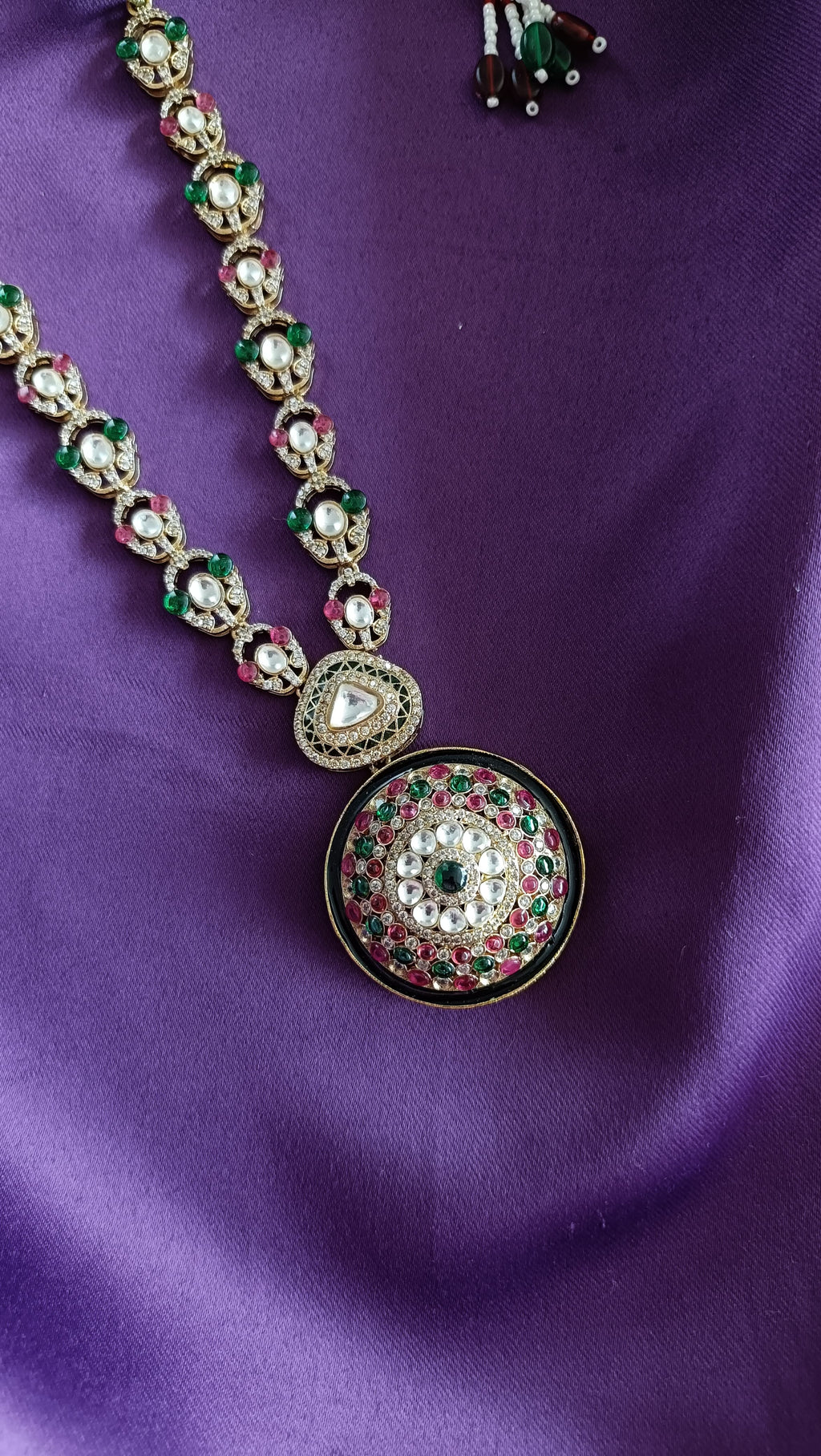 Gold Kundan Polki Ruby & Emerald Earrings front and back detail flat lay on purple fabric