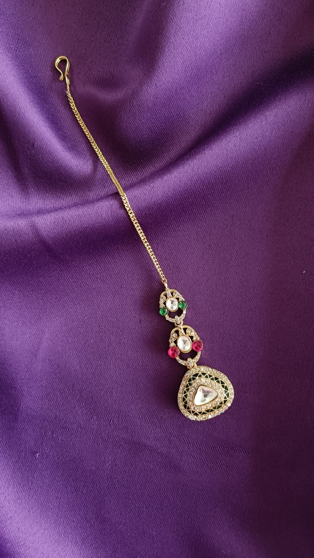 Gold Kundan Polki Ruby & Emerald Long Necklace chain motif detail close-up flat lay on purple fabric