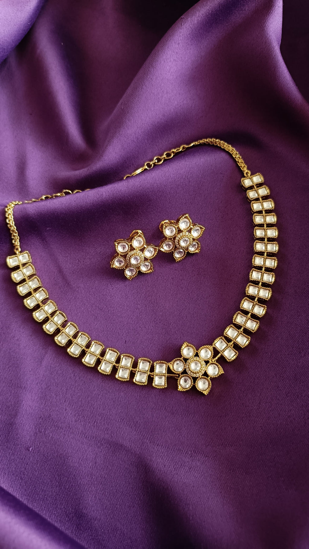 Gold Floral Kundan Polki Stud Earrings front and back detail flat lay on purple fabric