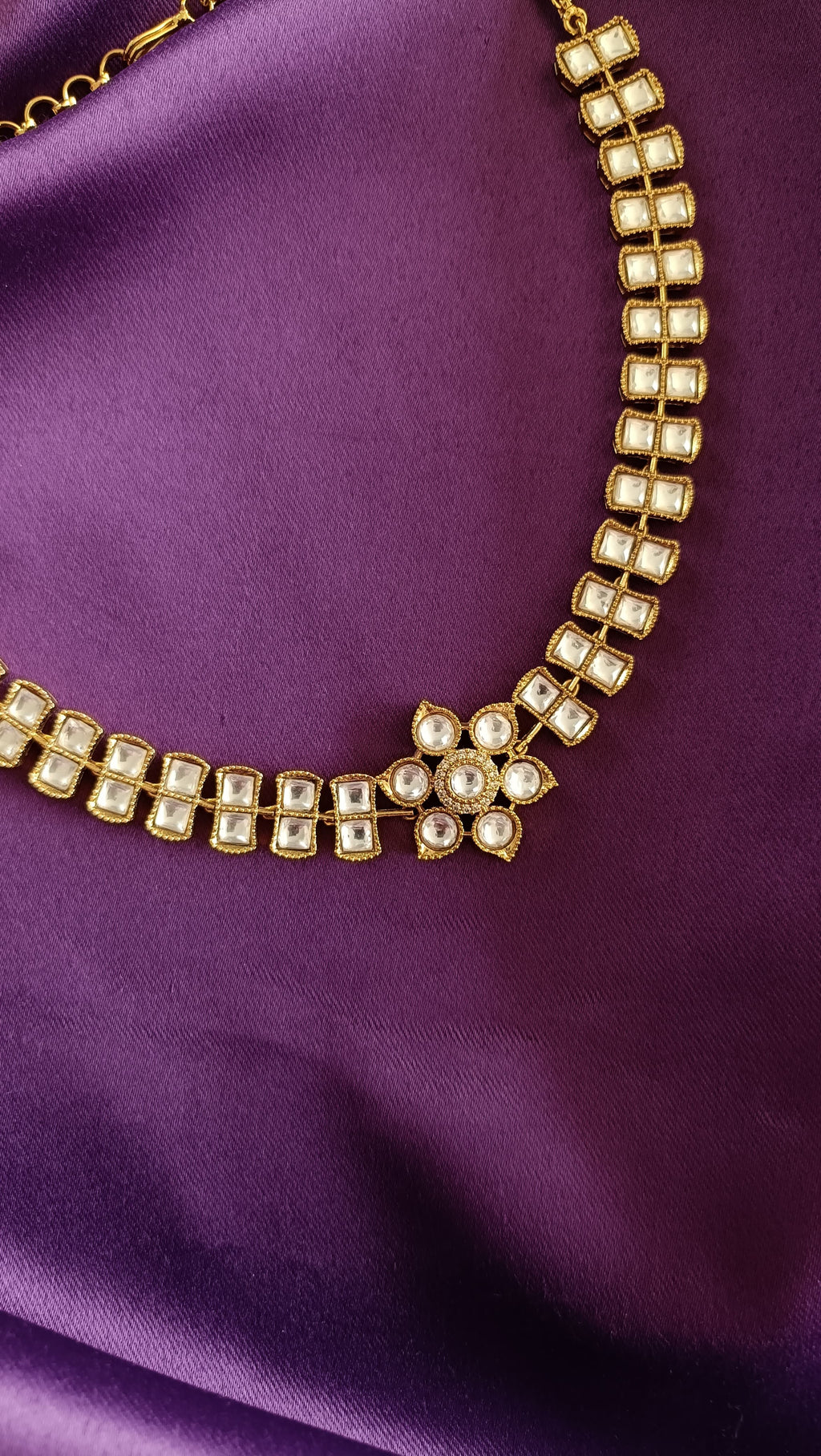 Gold Double-Row Square Kundan Polki Choker necklace close-up flat lay on purple fabric