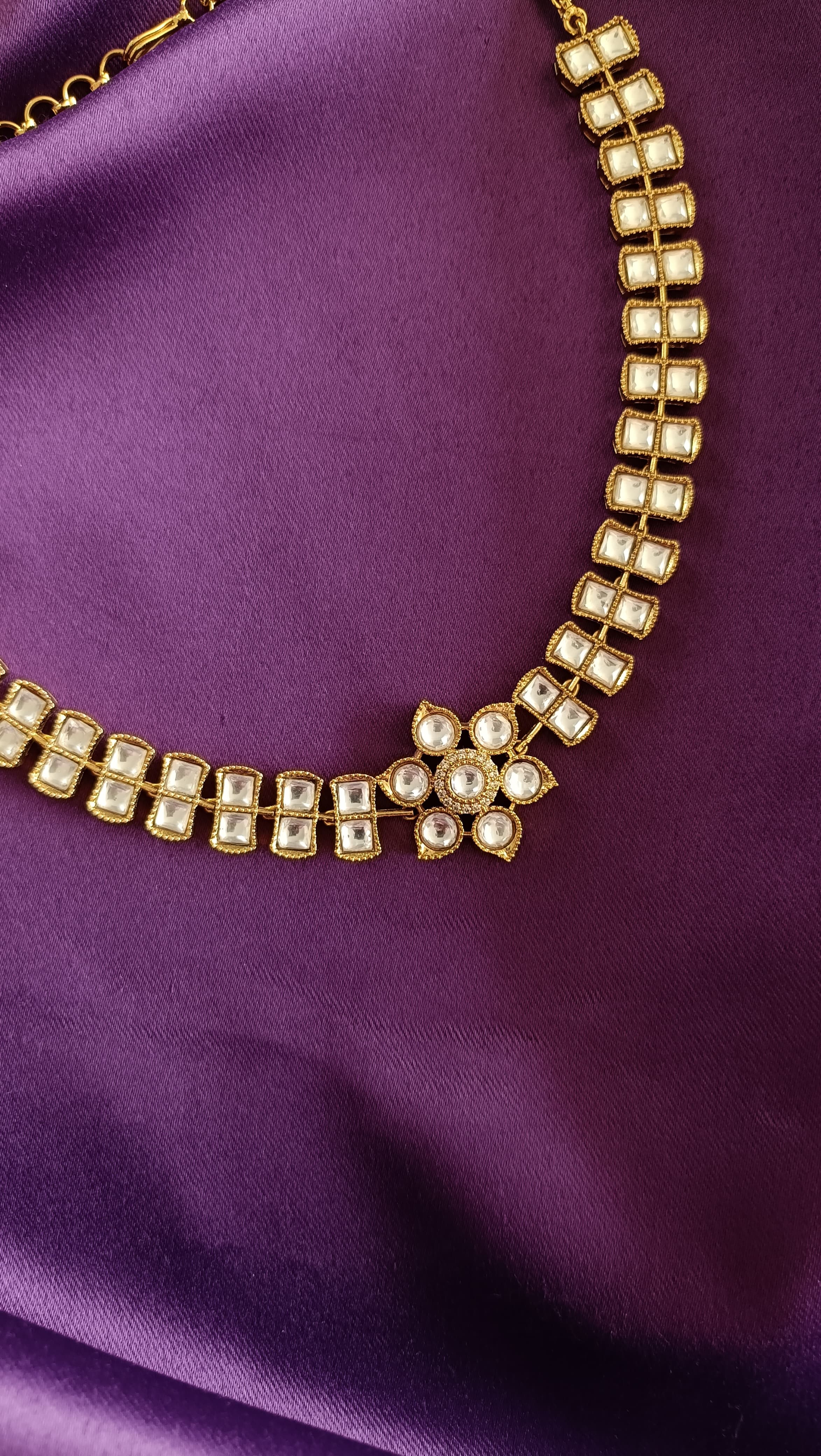 Gold Double-Row Square Kundan Polki Choker necklace close-up flat lay on purple fabric