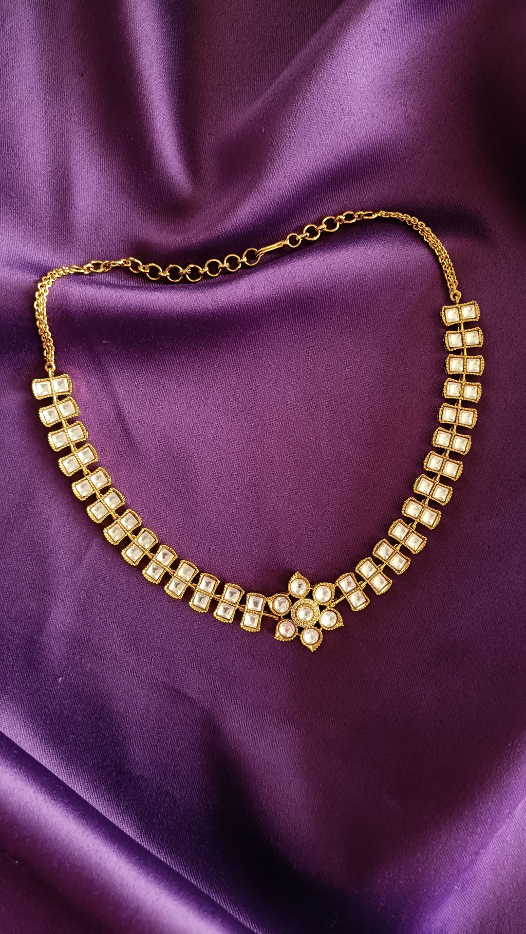 Gold Double-Row Square Kundan Polki Choker necklace full length flat lay on purple fabric with chain extender