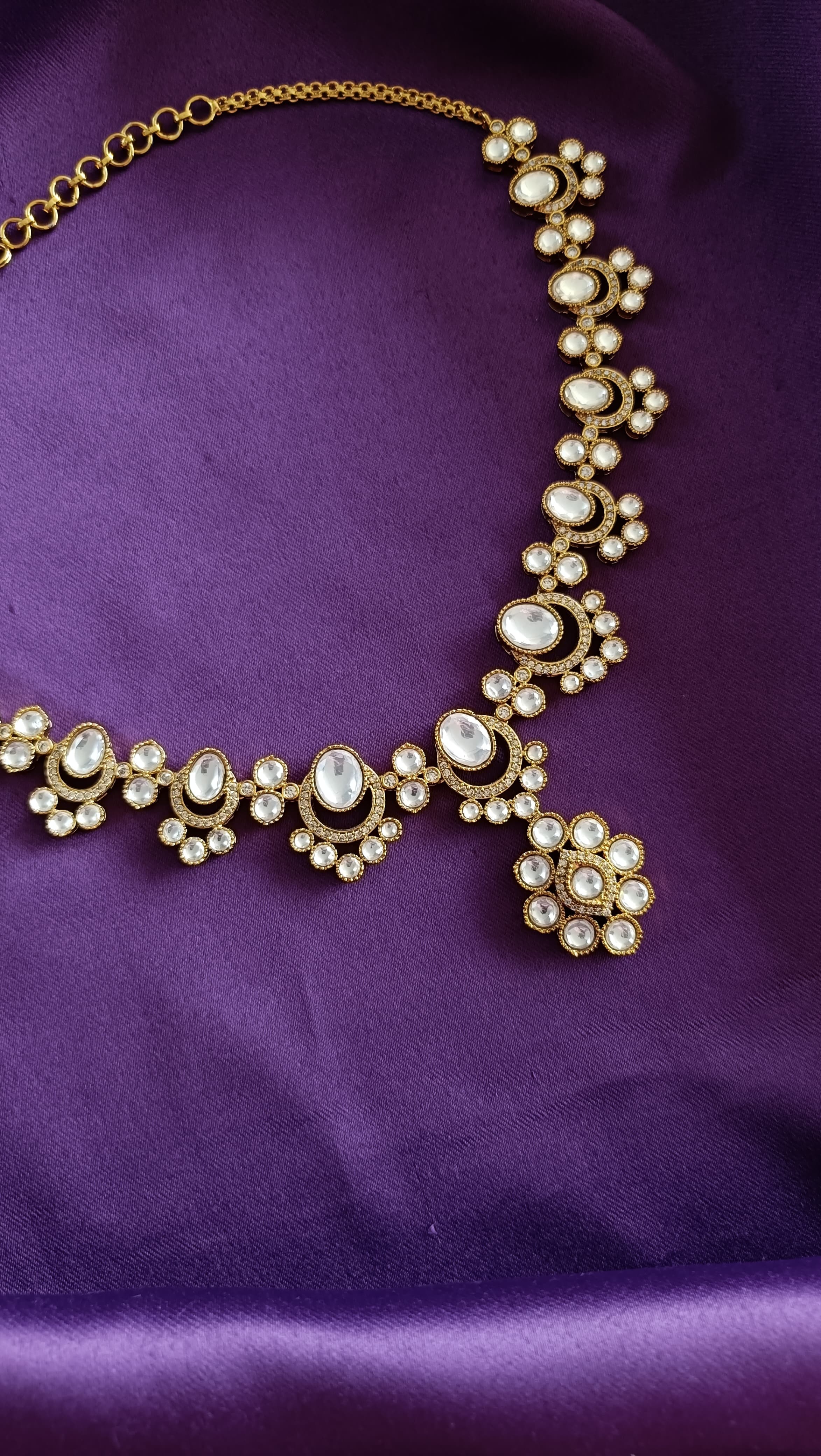 Gold Kundan Polki Floral Cluster Necklace close-up flat lay on purple fabric