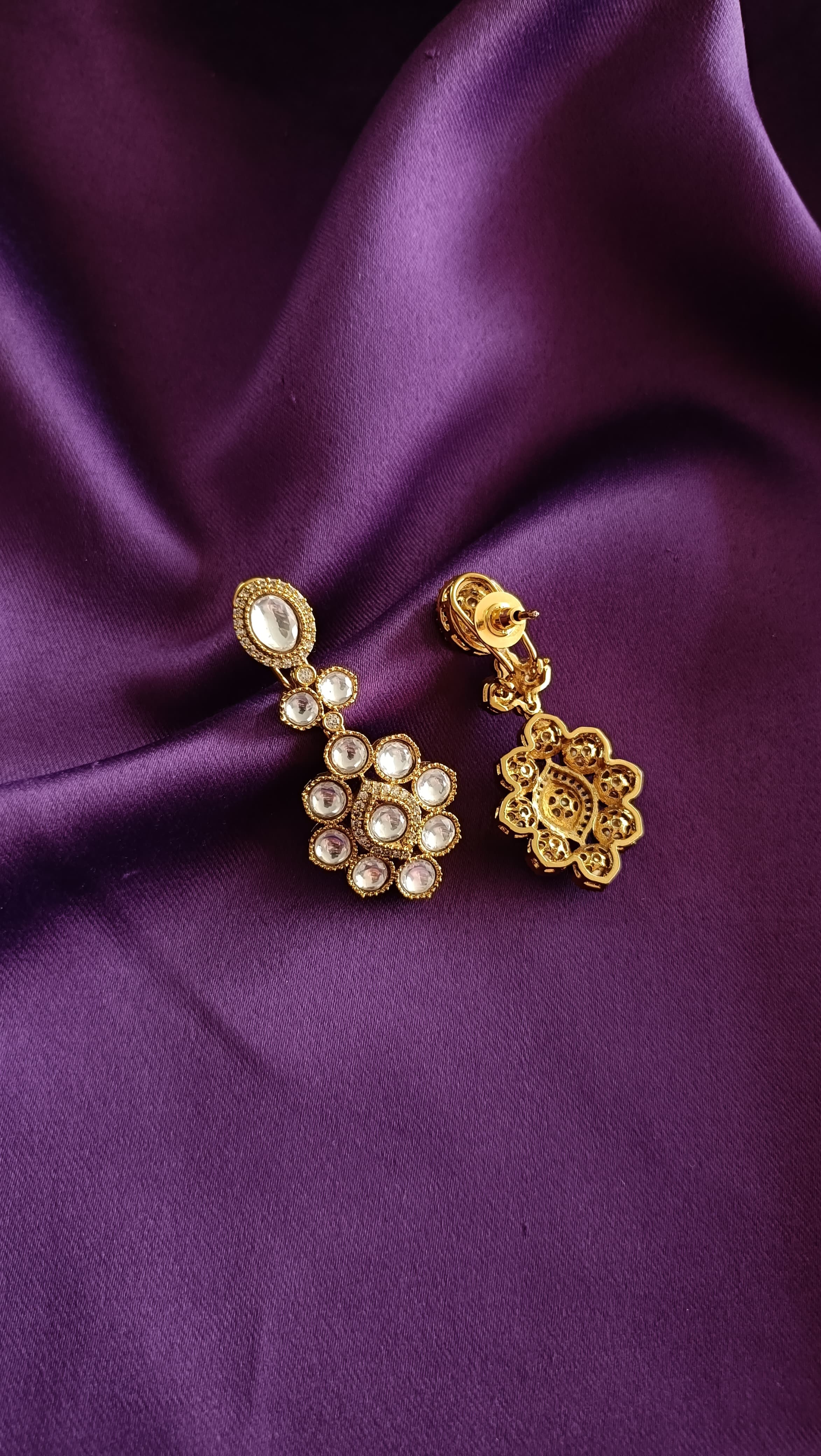Gold Kundan Polki Floral Cluster Drop Earrings front and back detail flat lay on purple fabric