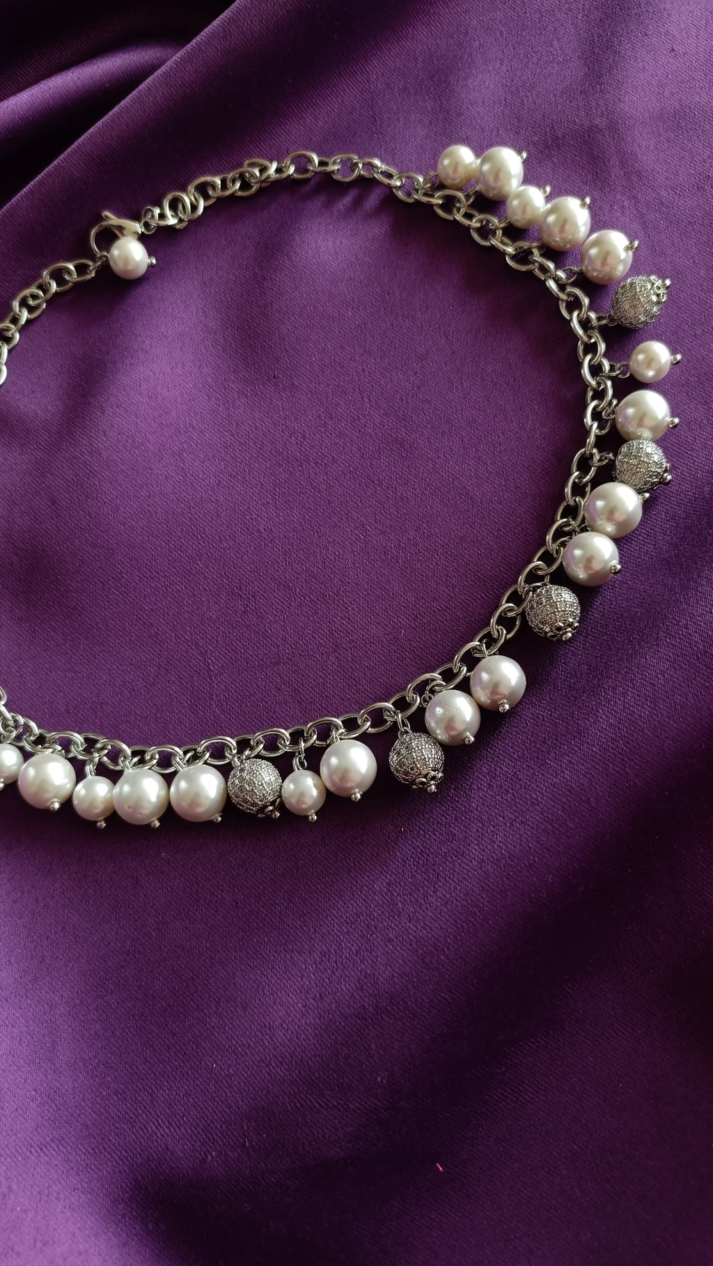 Silver Pearl & Pavé Ball Charm Choker necklace close-up flat lay on purple fabric showing alternating pearl and pavé ball charms