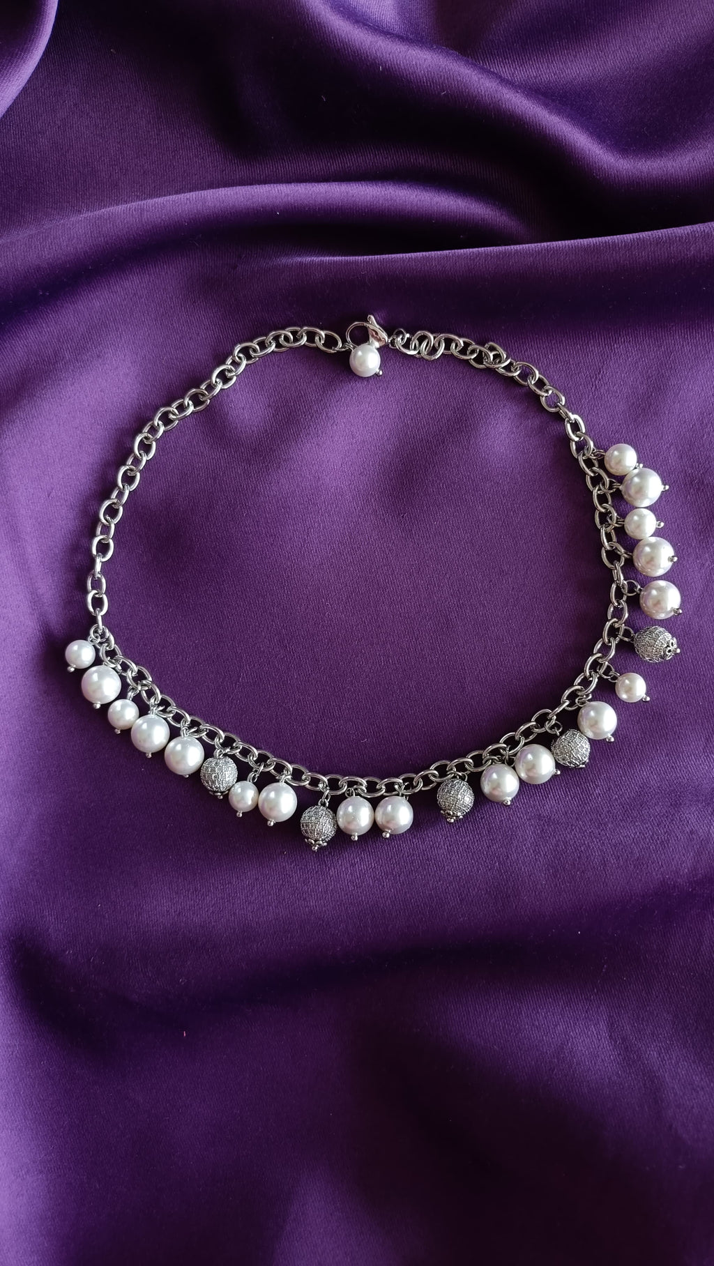 Silver Pearl & Pavé Ball Charm Choker necklace full length flat lay on purple fabric showing lobster clasp and pearl charm fringe