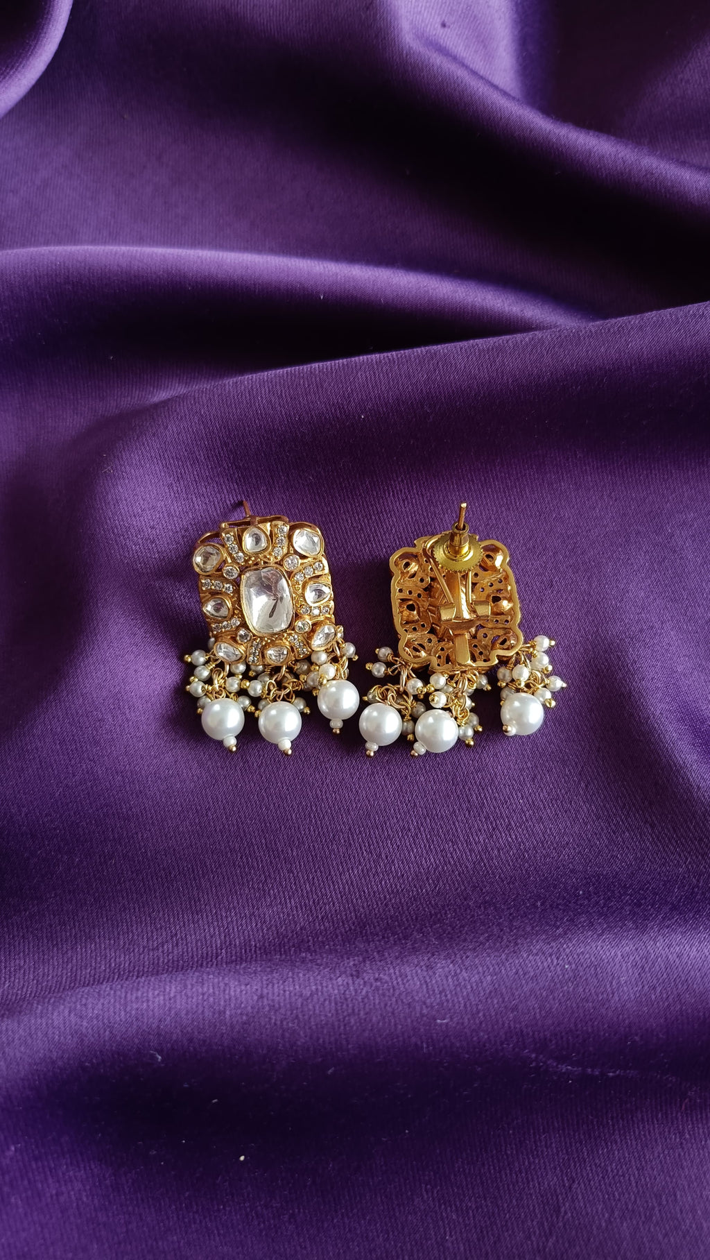 Gold Kundan Polki Rectangular Pendant Multi-Strand Seed Pearl Necklace & Earrings Set full flat lay on purple fabric