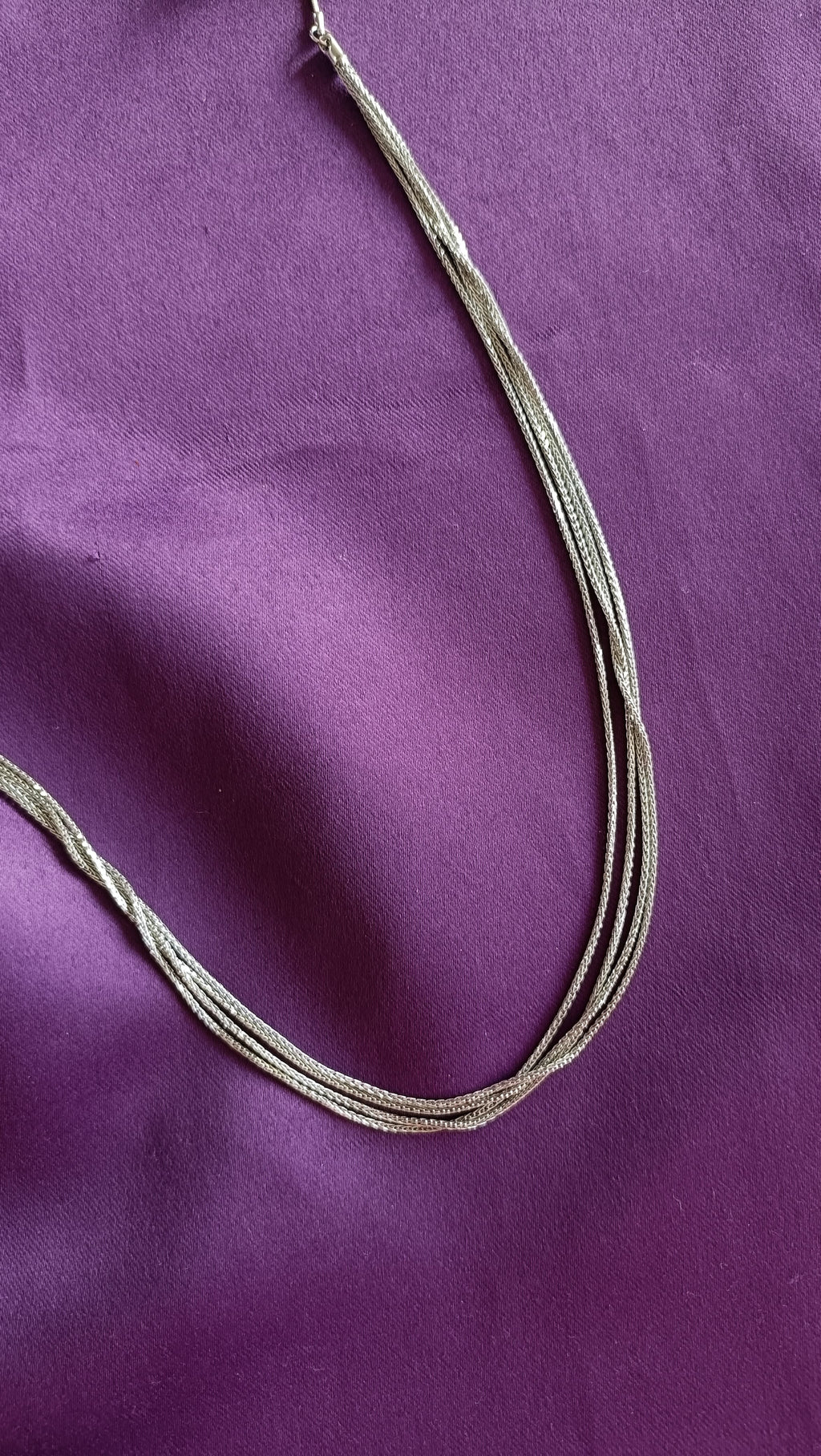 Silver Pearl & Ball Station Long Tassel Chain Necklace tassel detail flat lay on purple fabric