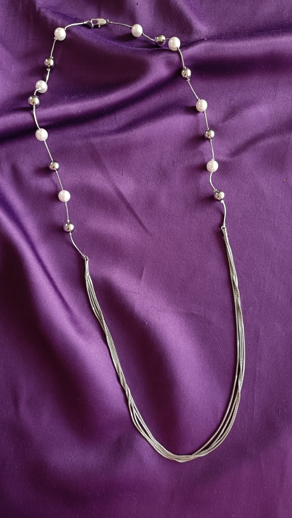 Silver Pearl & Ball Station Long Tassel Chain Necklace full length flat lay on purple fabric