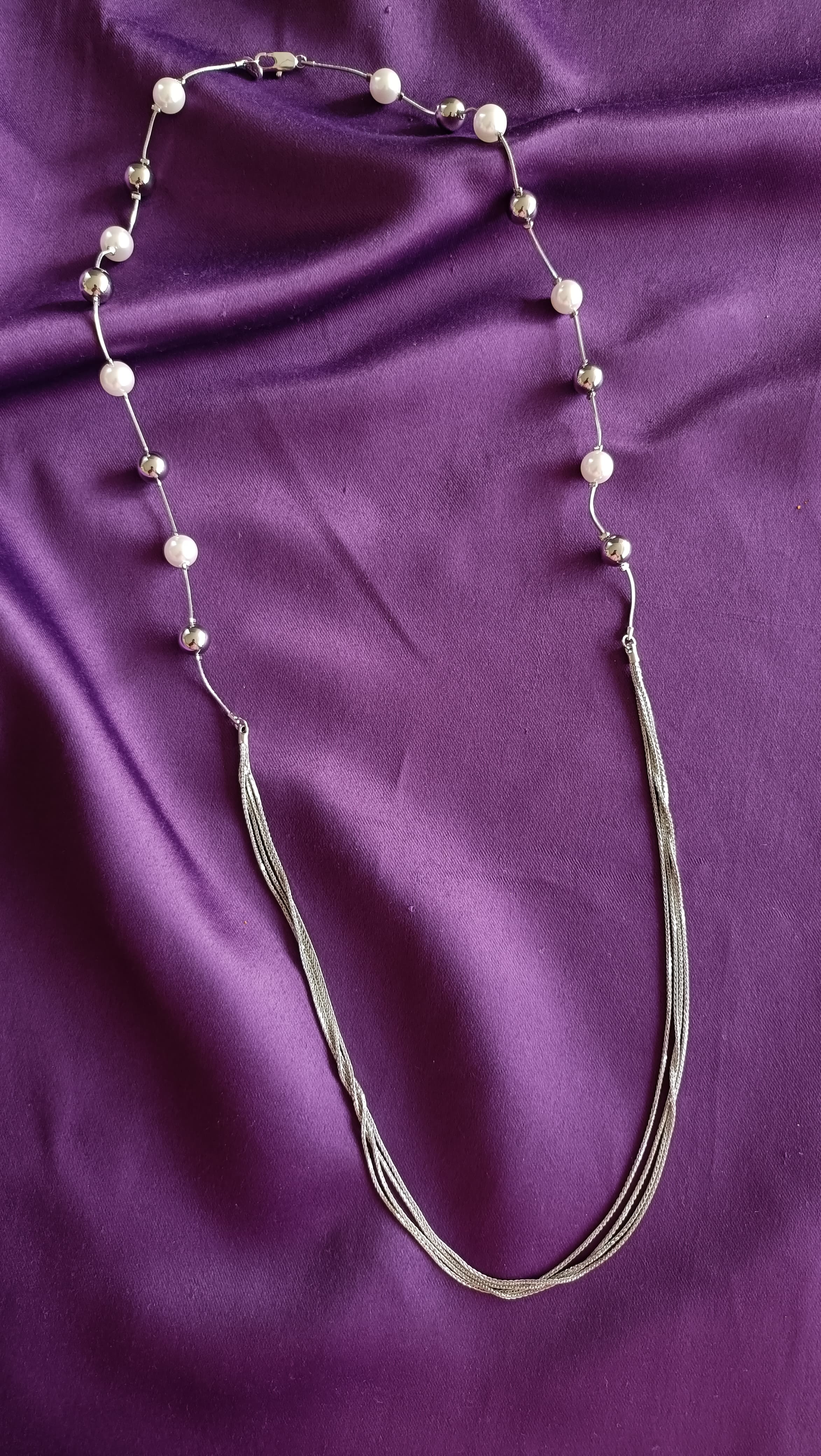 Silver Pearl & Ball Station Long Tassel Chain Necklace full length flat lay on purple fabric