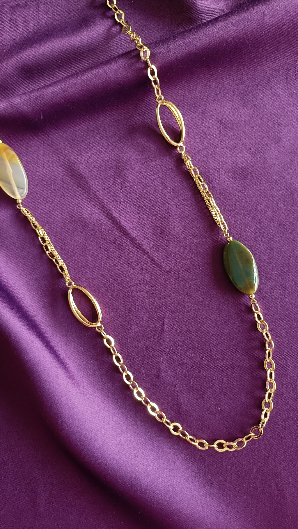 Gold Mixed-Chain Green Onyx & Honey Agate Oval Station Long Necklace centre detail close-up flat lay on purple fabric showing open oval rings, agate and onyx stations