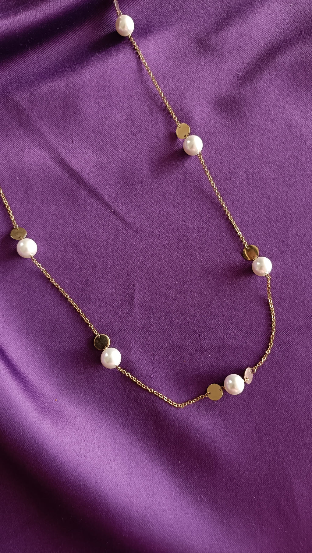 Gold Pearl & Coin Disc Station Long Necklace centre detail flat lay on purple fabric