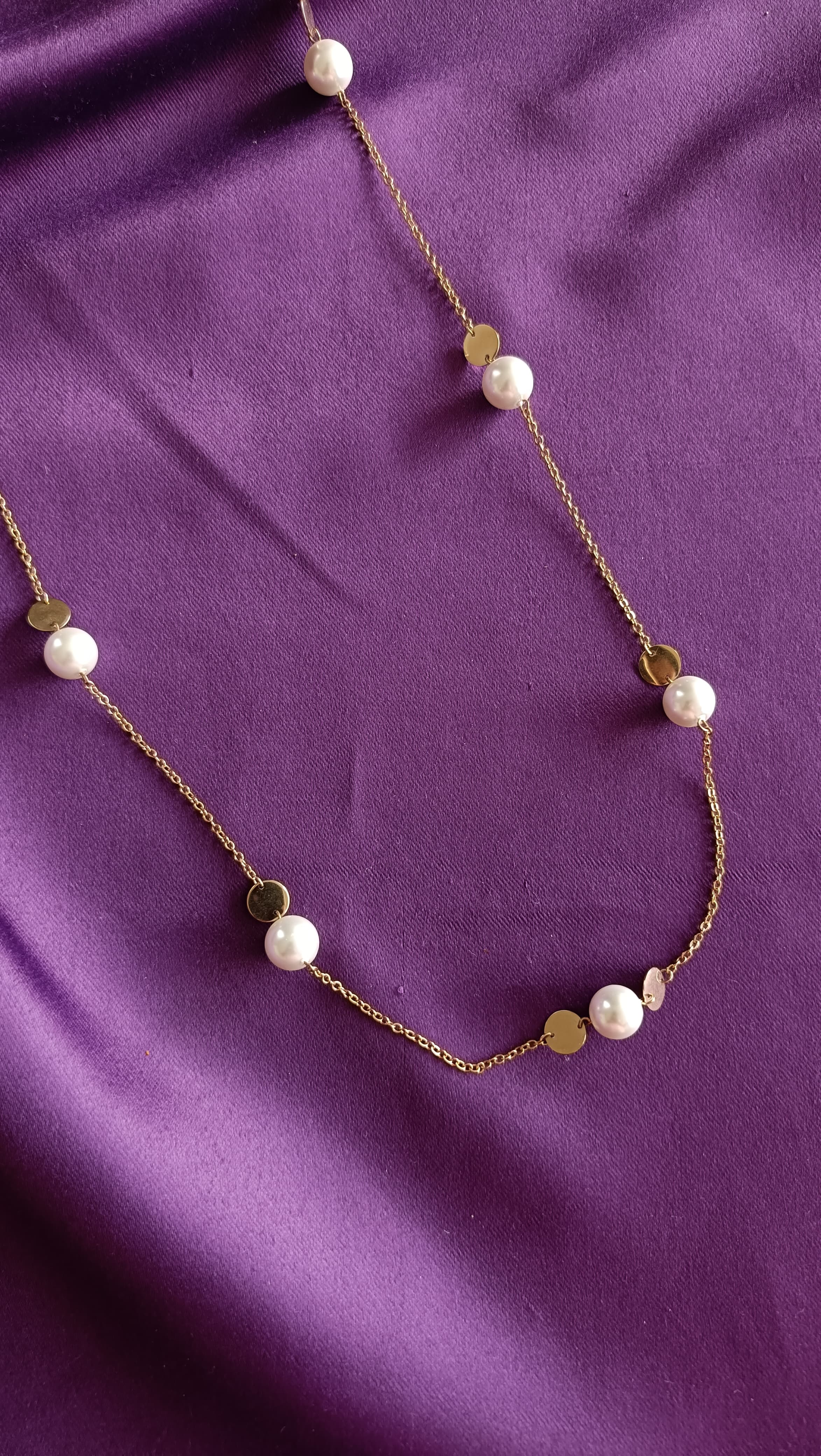 Gold Pearl & Coin Disc Station Long Necklace centre detail flat lay on purple fabric