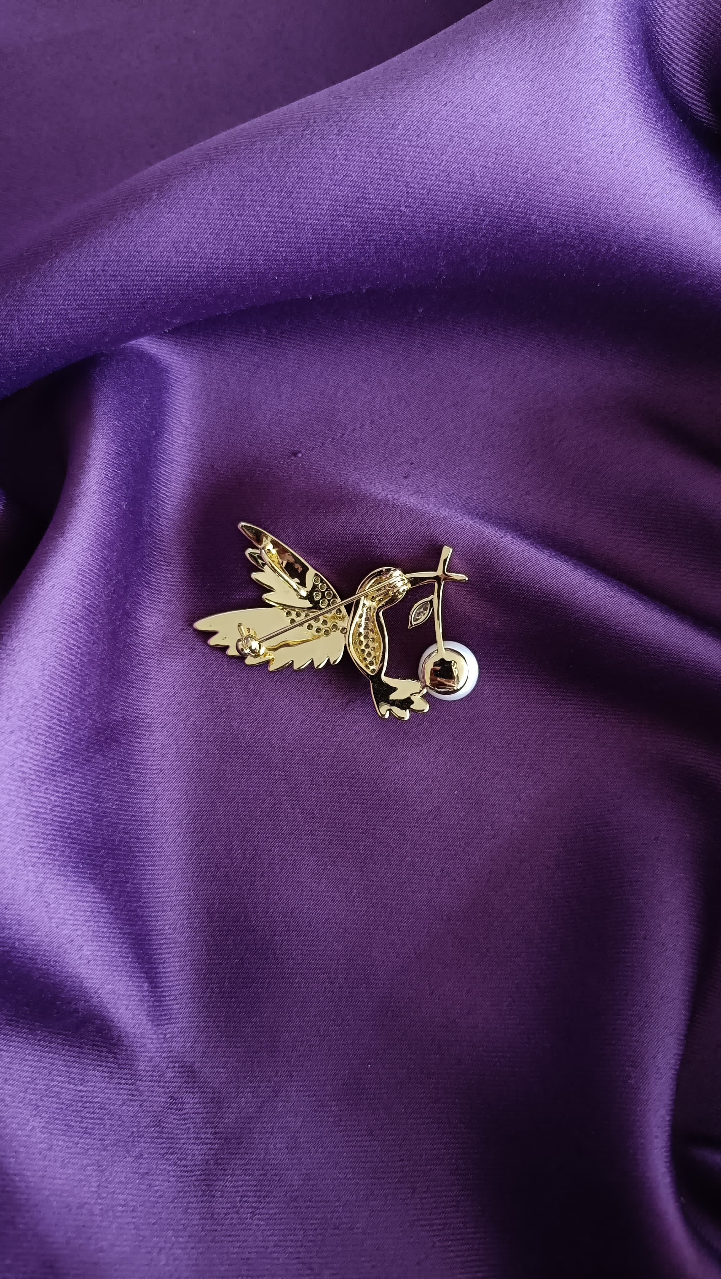 Gold Teal Enamel Hummingbird Pavé Body Lapel Brooch Pin with Pearl Drop reverse side flat lay on purple fabric showing pin back closure